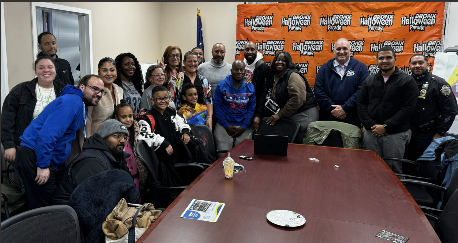 Community members and staff gathered at Bronx Halloween Parade meeting
