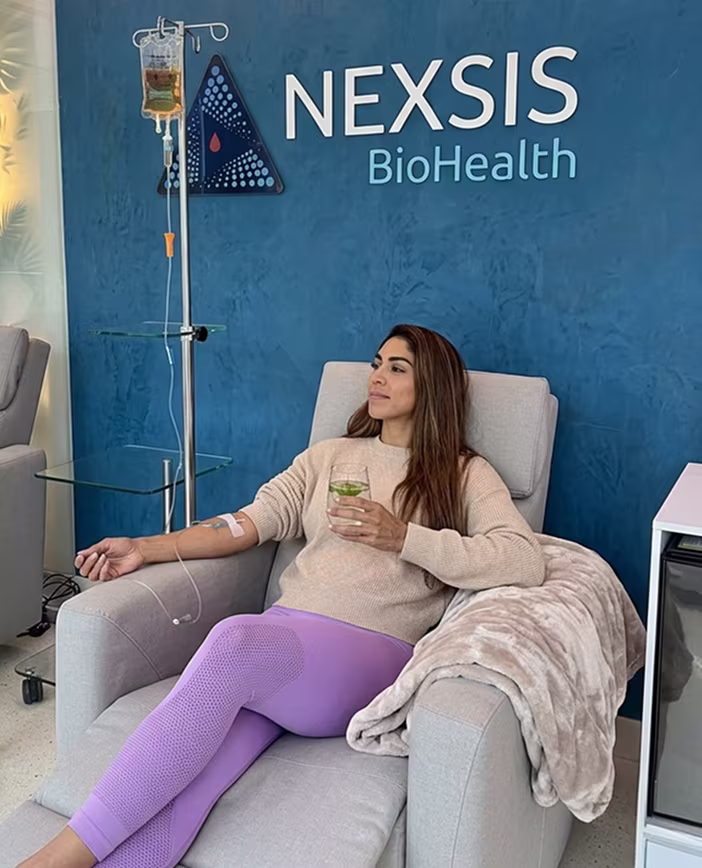 Patient receiving a glutathione IV drip in a private treatment room at Nexsis BioHealth in Brickell, Miami