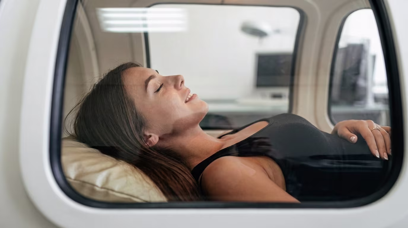 Patient resting comfortably inside a hyperbaric oxygen chamber during a 60-minute HBOT session