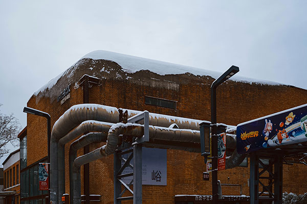 Photo of a building covered by snow, by Tommao Wang.