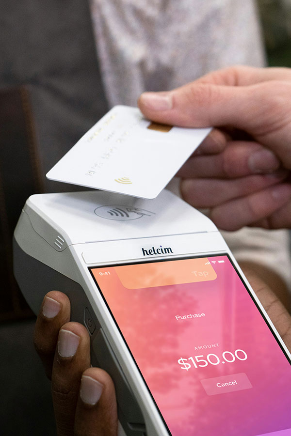 Photo of a person paying with credit card, by Helcim Payments.