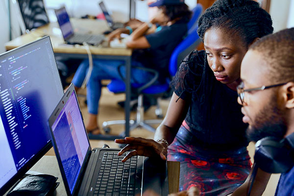 Two people implementing software, by Desola Lanre.