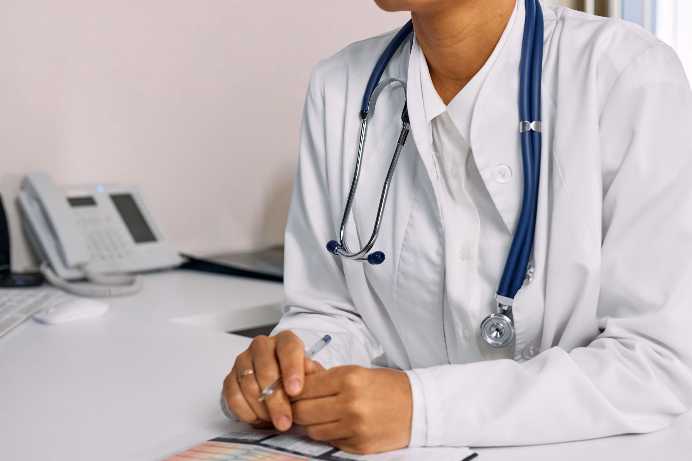 Allergist consulting with a patient at a desk
