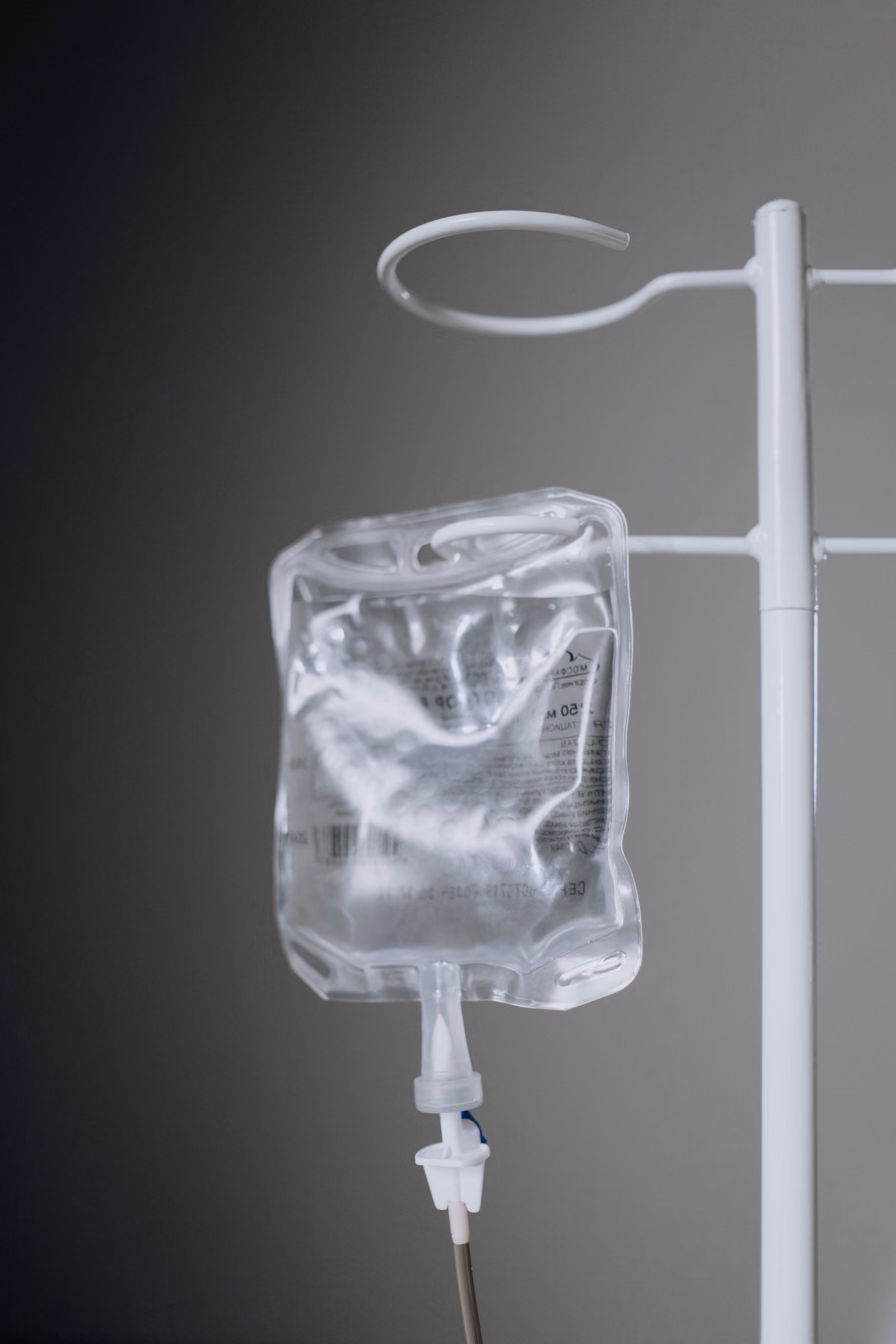 Intravenous infusion bag on a stand in a treatment room