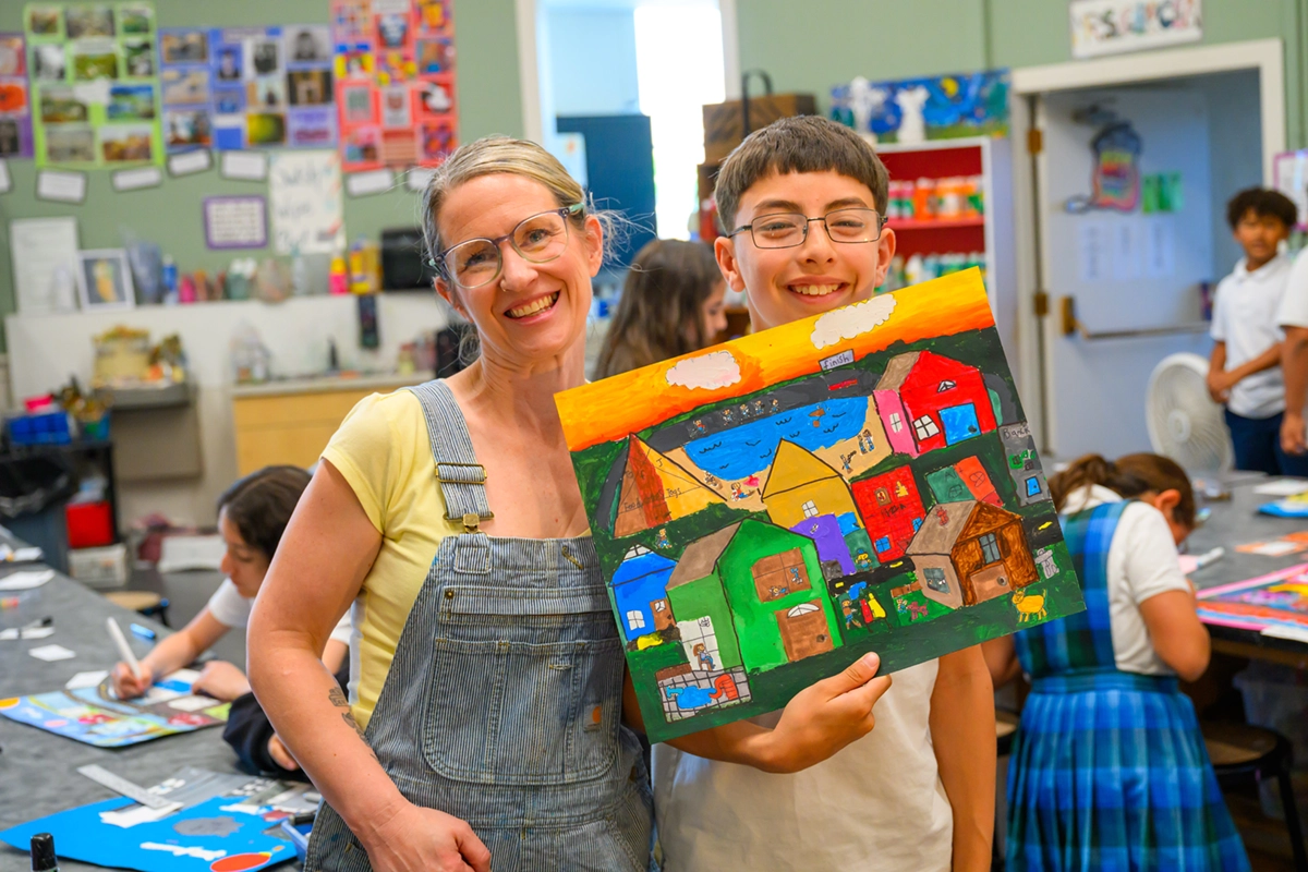 A student and teacher sharing a joyful moment at St. Joseph Marquette Catholic School in Yakima