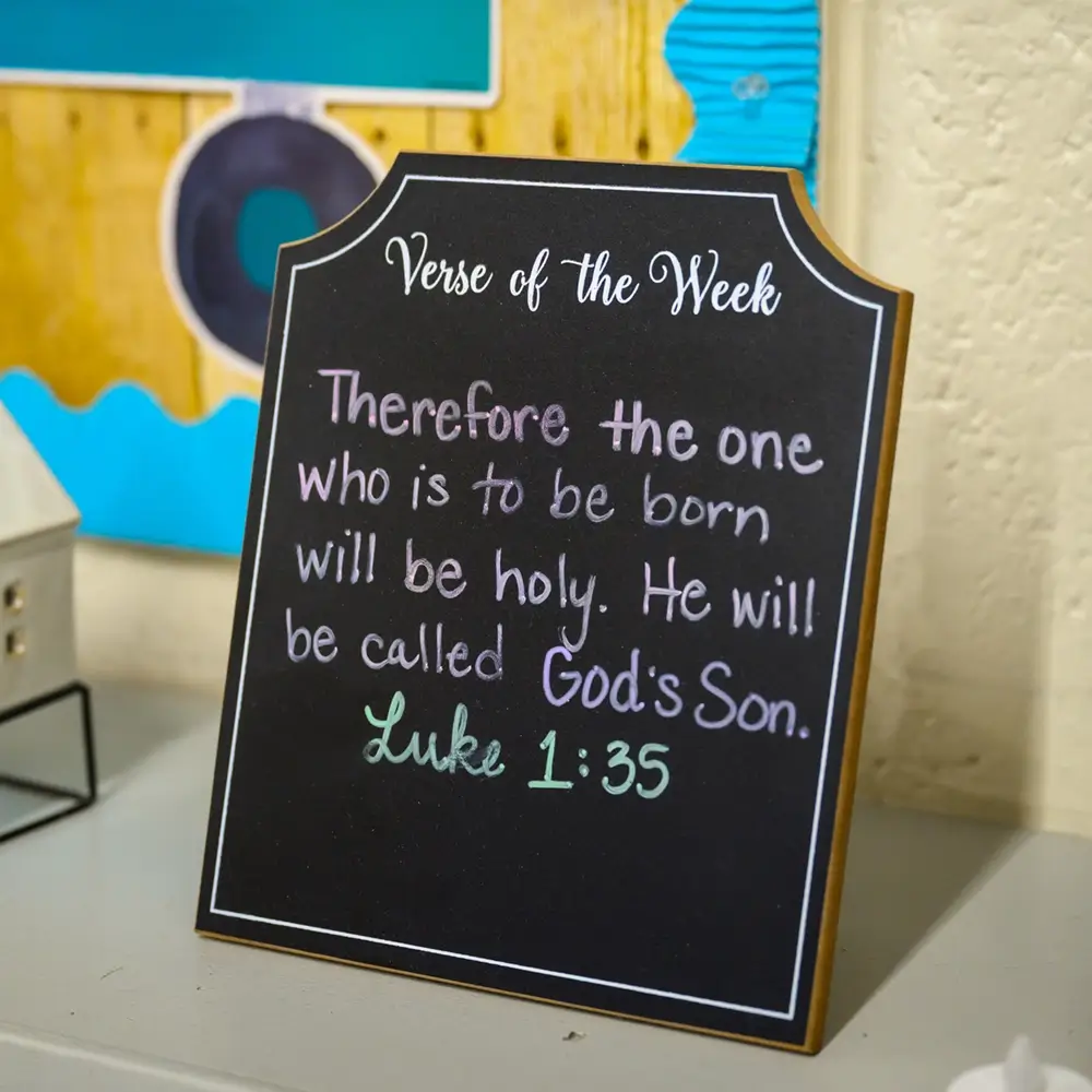 A Verse of the Week chalkboard sign displaying Luke 1:35 at St. Joseph Marquette Catholic School in Yakima