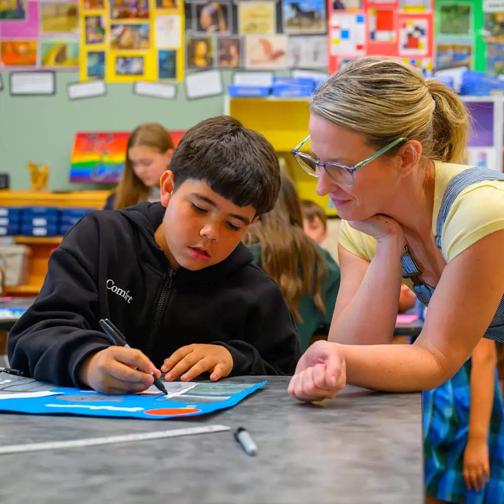 A teacher giving one-on-one attention to a student at St. Joseph Marquette Catholic School in Yakima