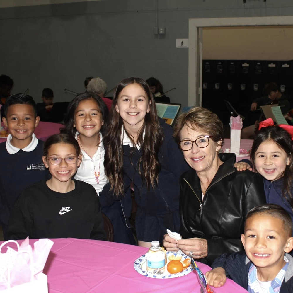 Families sharing a meal at a community dinner at St. Joseph Marquette Catholic School in Yakima