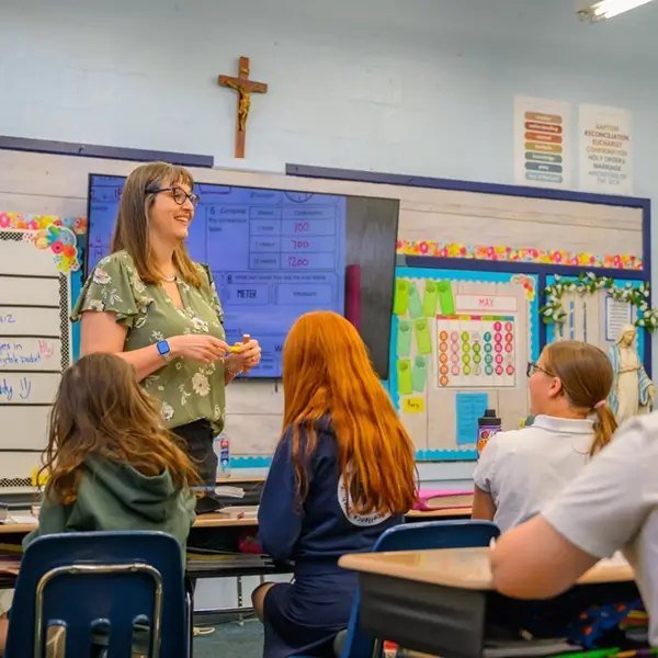 A teacher helping students at their desks at St. Joseph Marquette Catholic School in Yakima