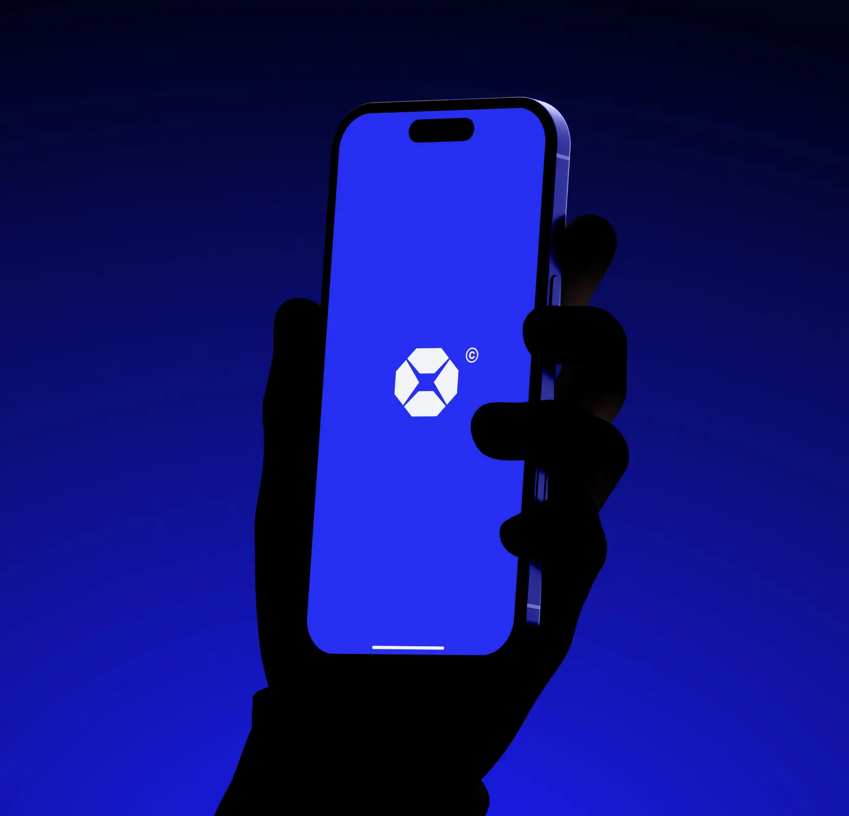 Silhouette of hand holding phone showing blue screen with white geometric logo and copyright symbol.