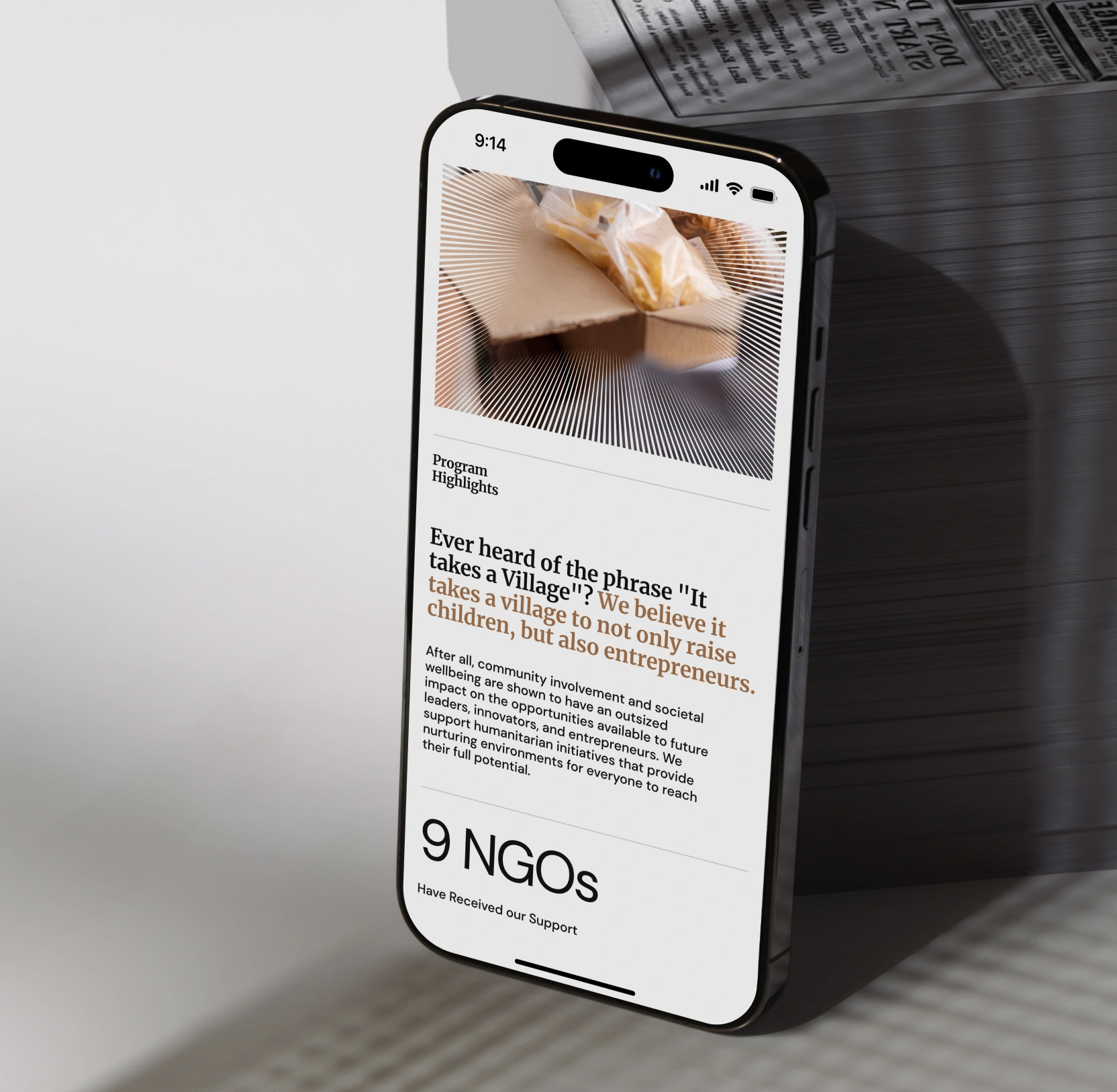 Smartphone displaying text about community support and entrepreneurs with image of packaged goods.