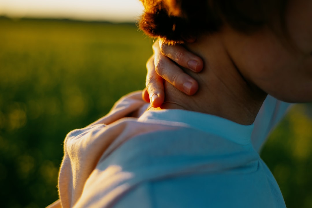woman touching her throat