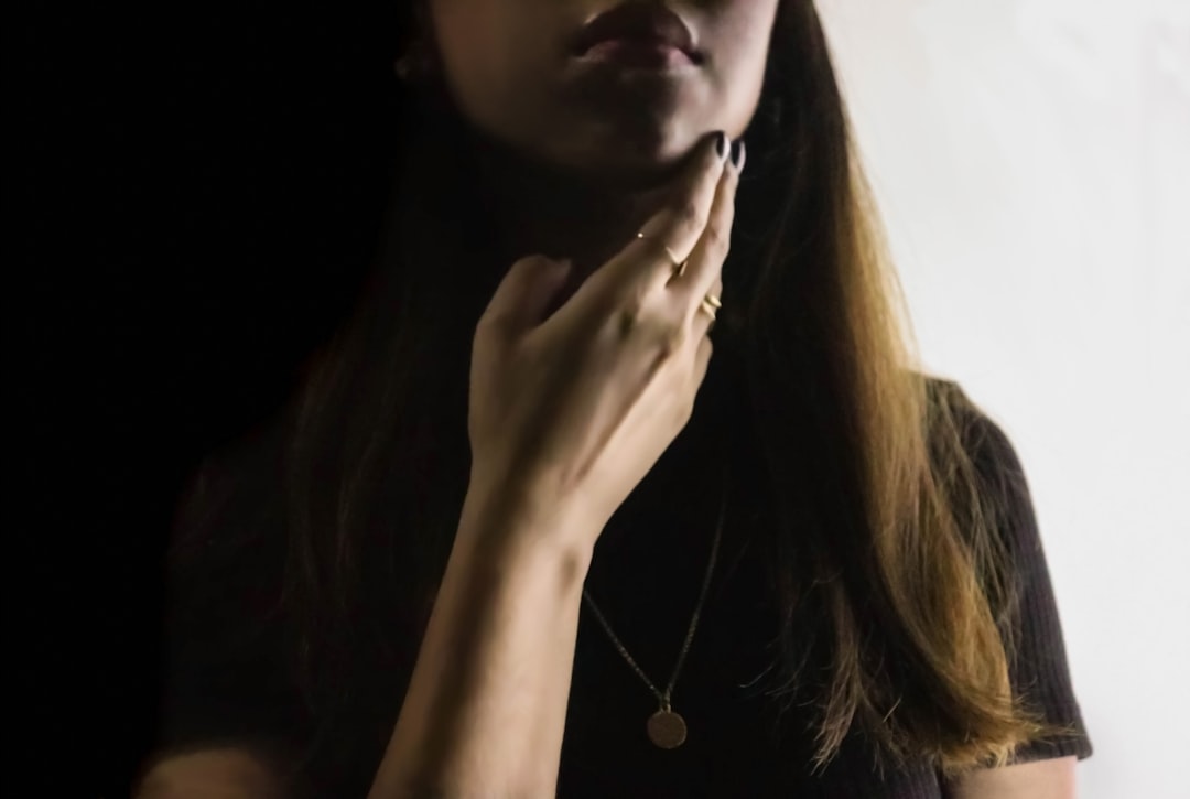 woman touching throat