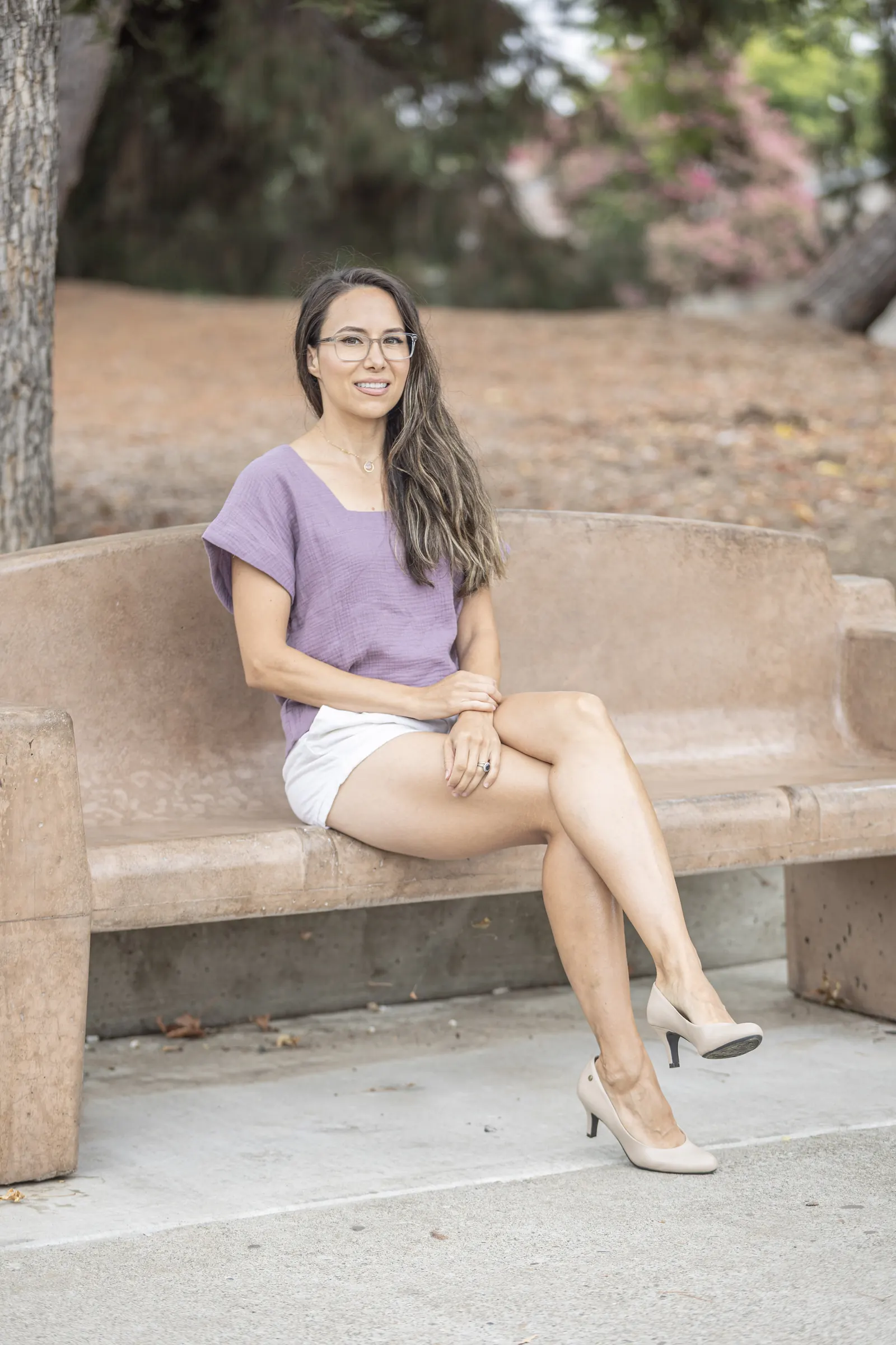 Gabby Covay, Bright Valley Marketing founder, sitting on a stone bench in a park