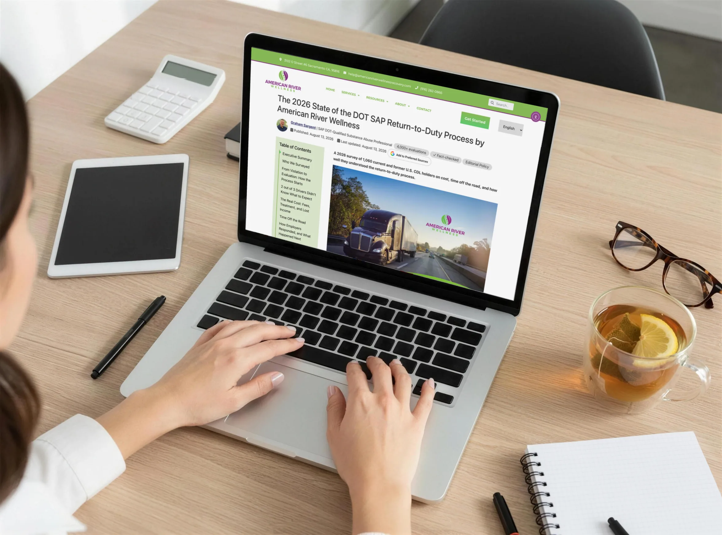 A laptop on a desk showing a client's survey report