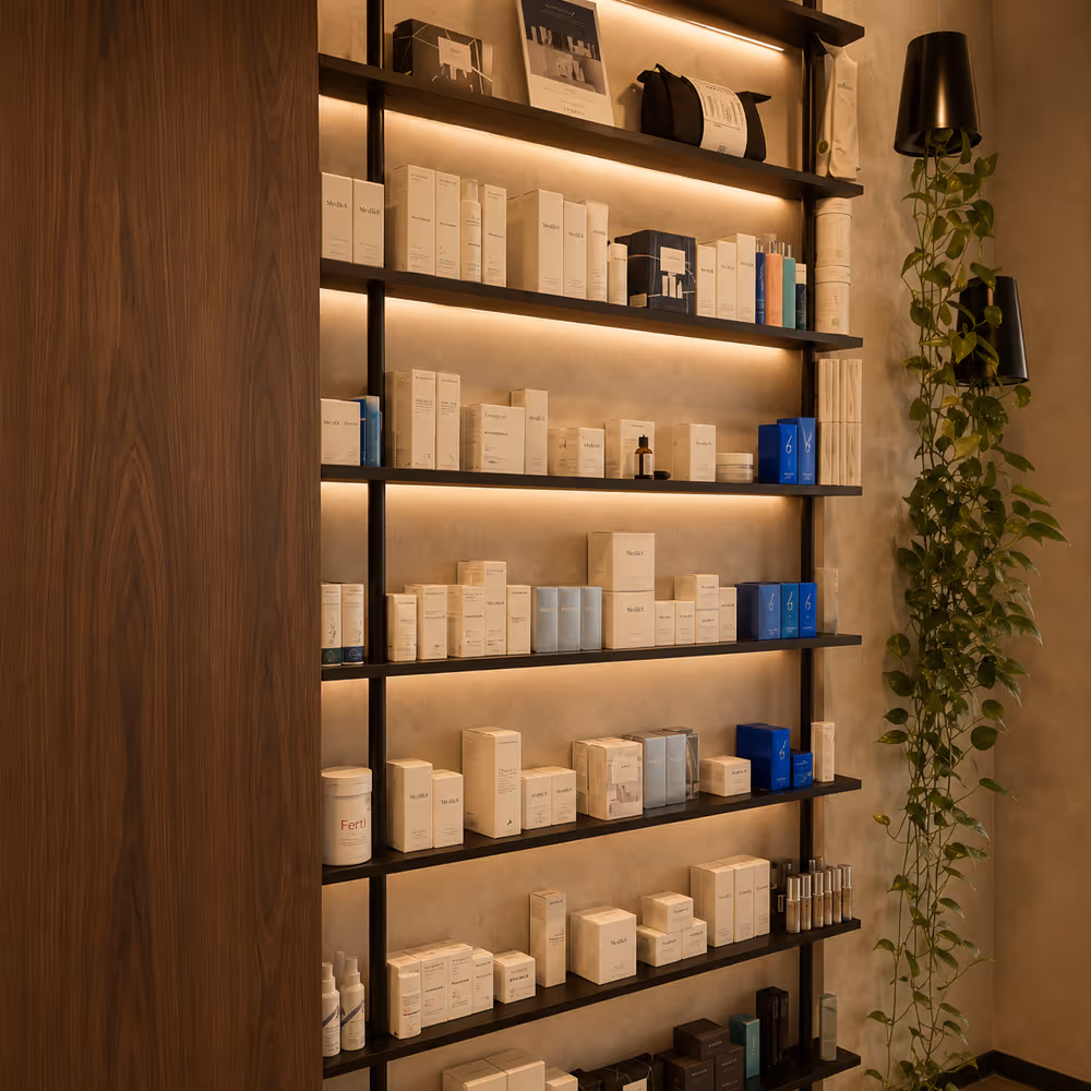 Shelves of skincare and beauty products with warm lighting and a trailing green plant on the right wall.