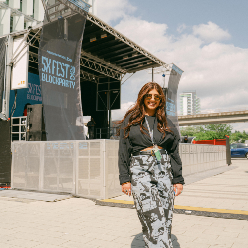 Harpo standing in front of 5X Festival Blockparty stage