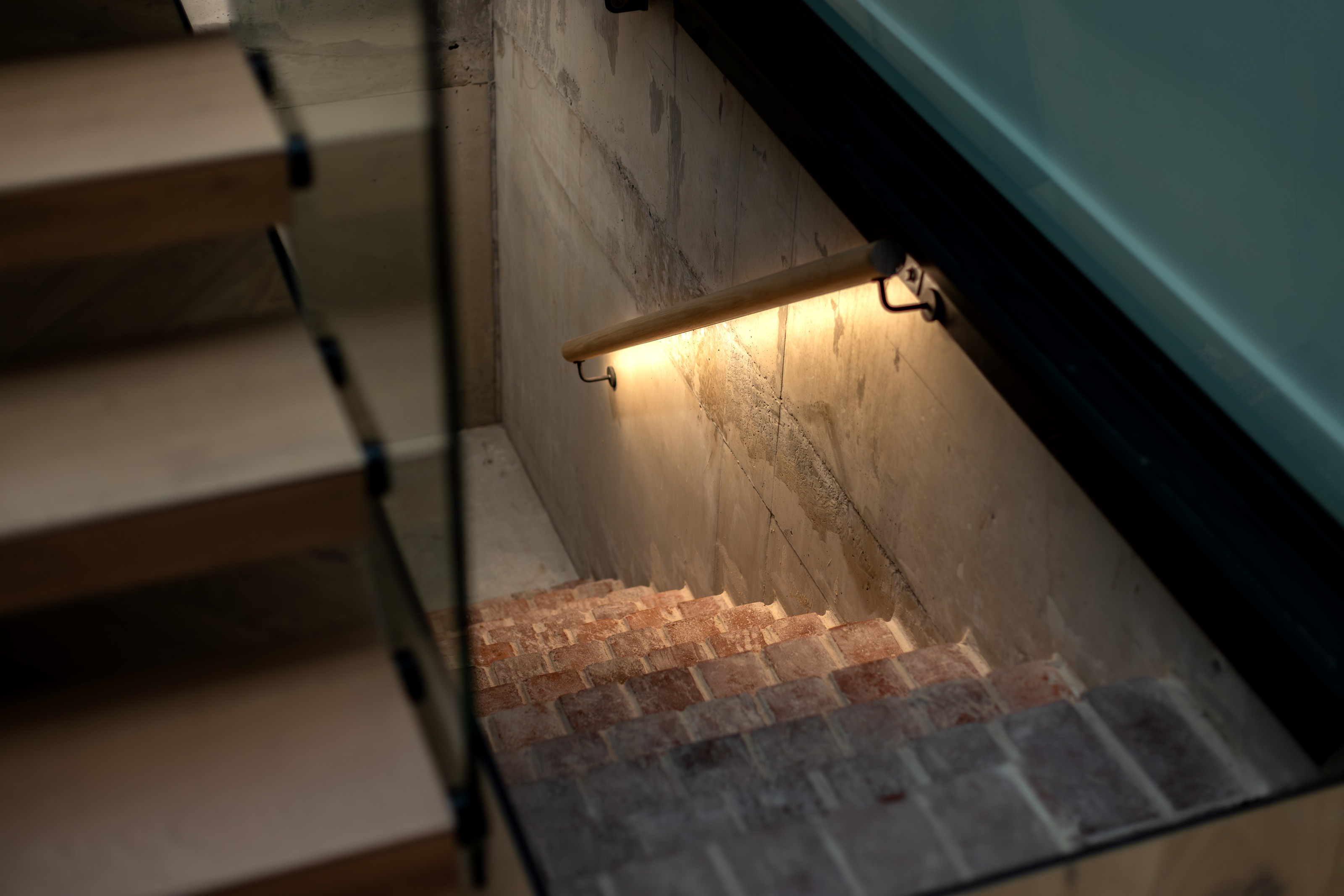 Original cellar stair with glass floor panel above and brick treads at 54 North Adelaide.