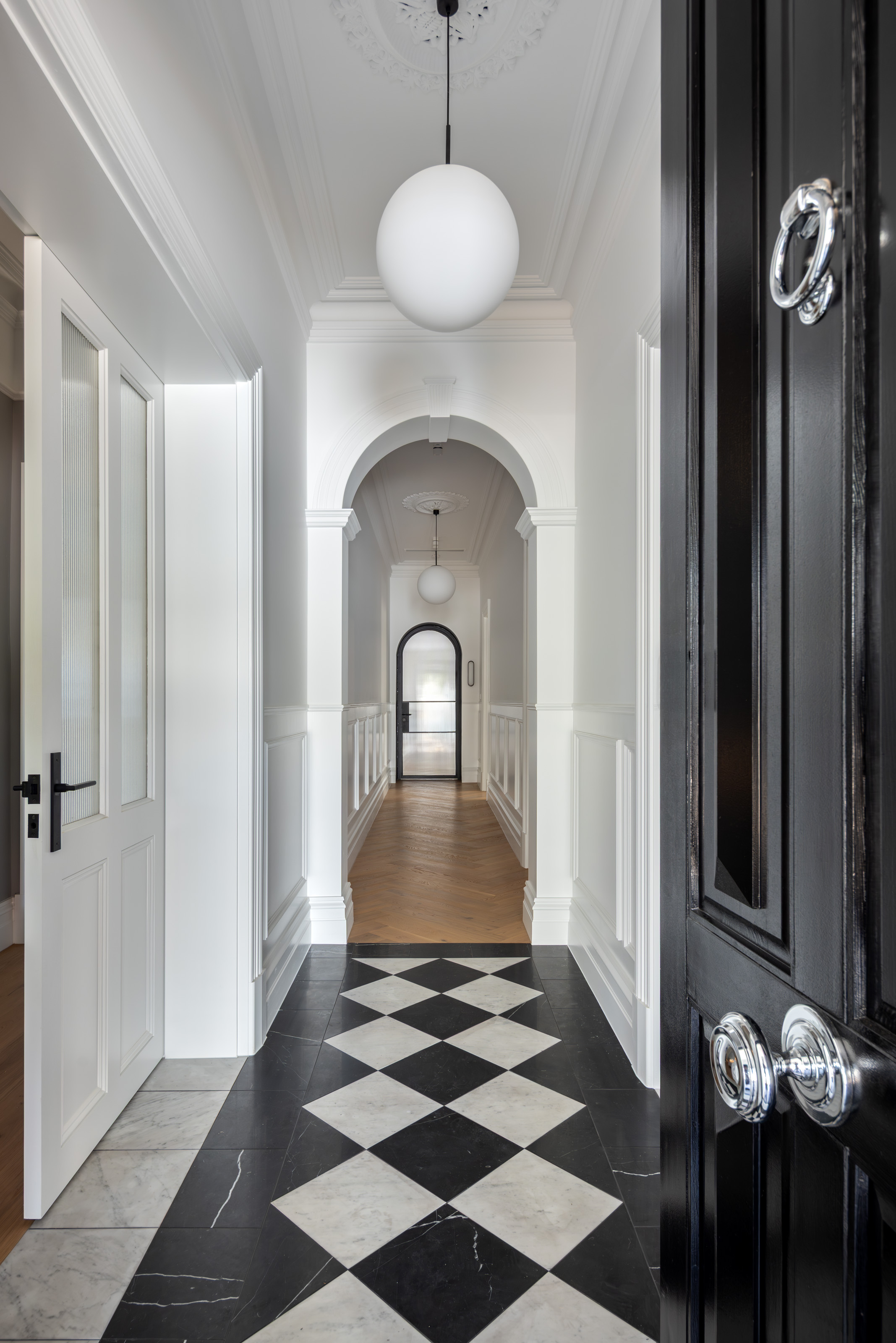 Hallway framed by a restored archway at 54 North Adelaide.
