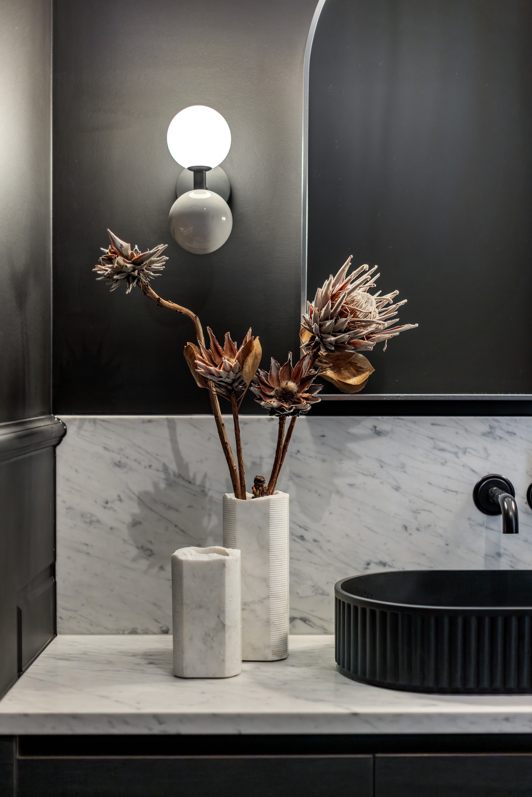 Marble vanity detail with dried floral arrangement at 54 North Adelaide.