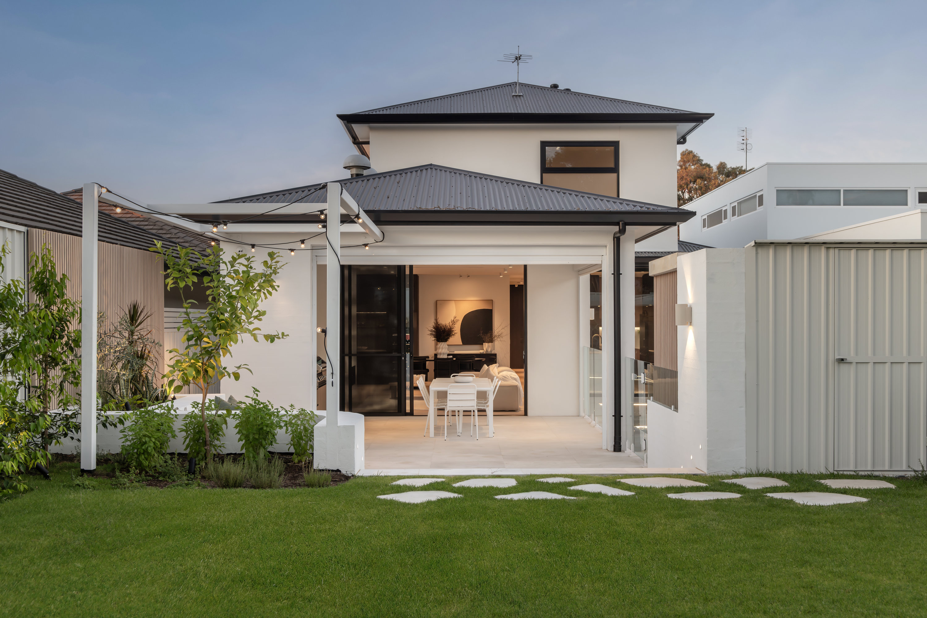Rear elevation with pergola and glazed doors opening to the lawn at 9 Netherby