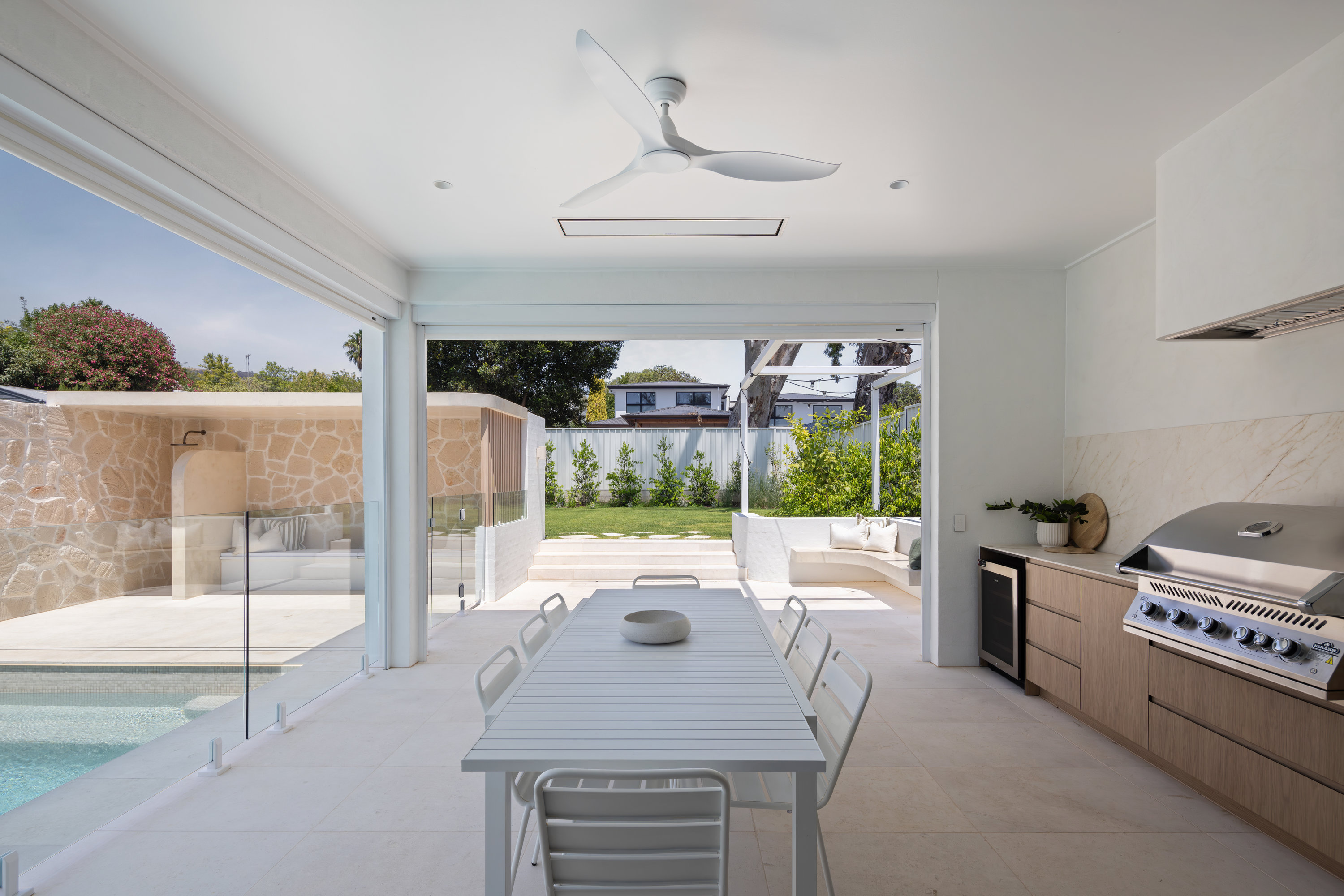 Alfresco kitchen and dining area looking through to the pool at 9 Netherby