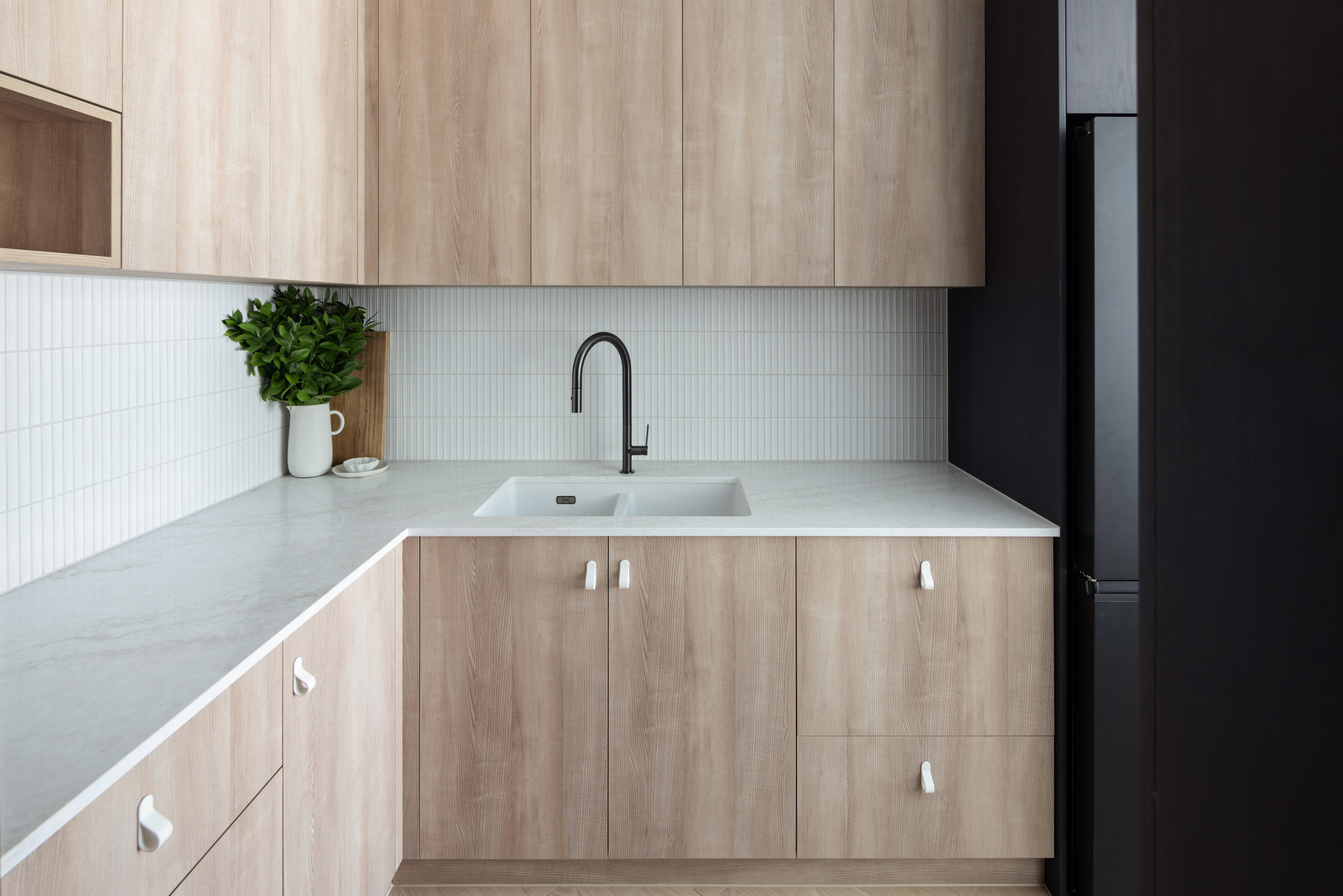 Butler's pantry with oak joinery, stone benchtop and black tapware at 9 Netherby