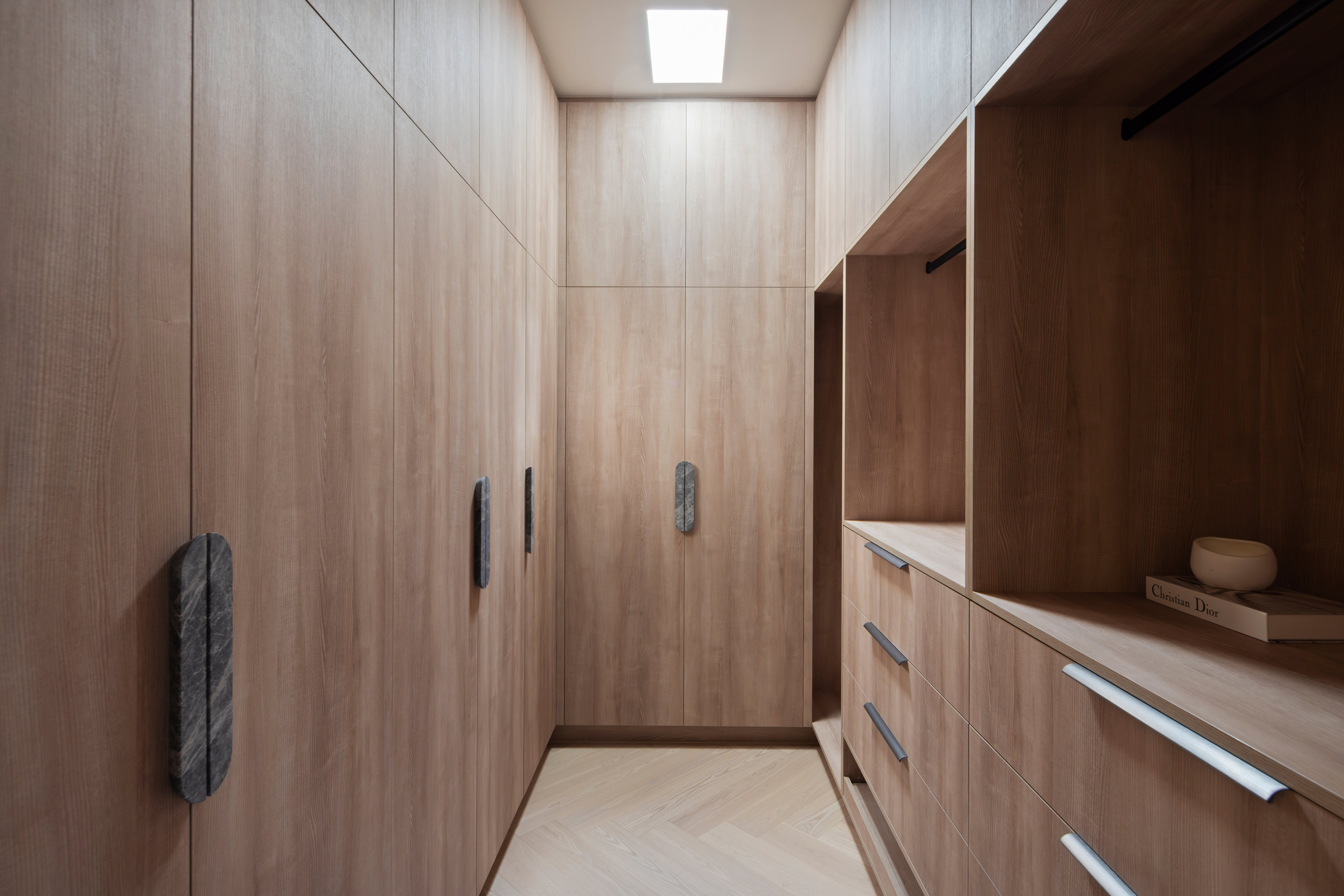 Walk-in robe with oak joinery, hanging rails and stone pull handles at 9 Netherby