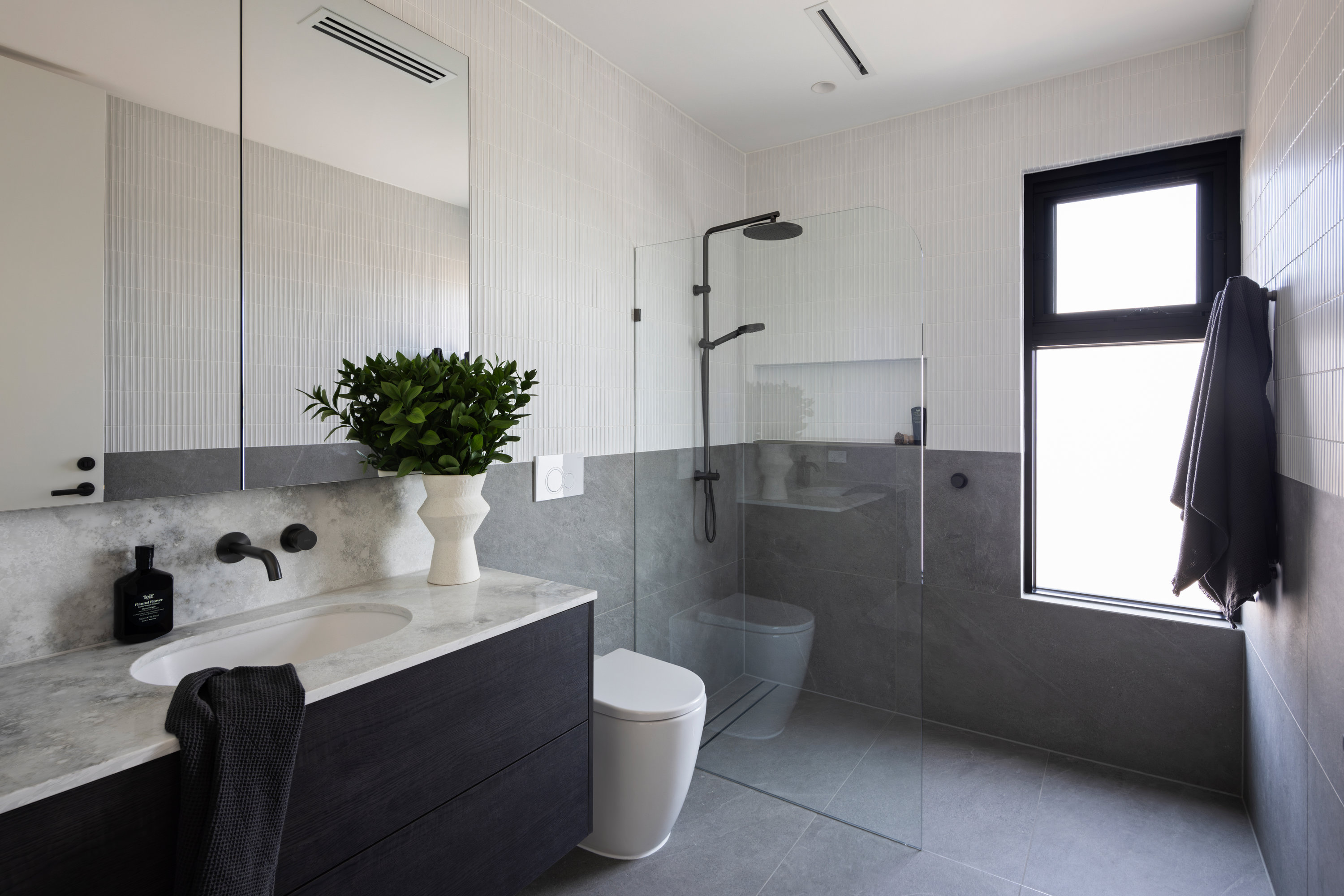 Bathroom with dark timber vanity, stone top and a walk-in shower at 9 Netherby