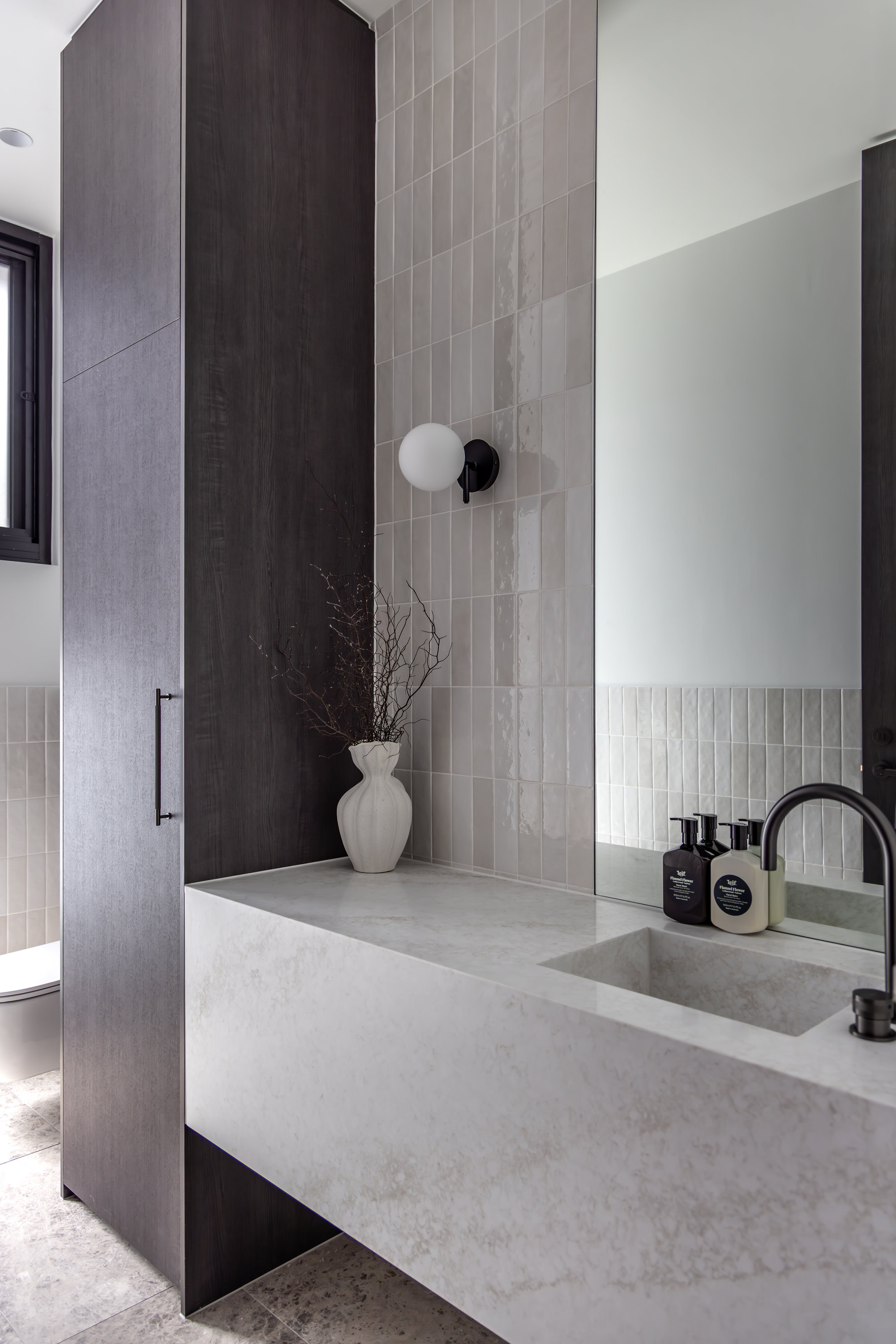 Bathroom with a stone wall-hung vanity, dark timber cabinetry and glazed tiles at 9 Netherby