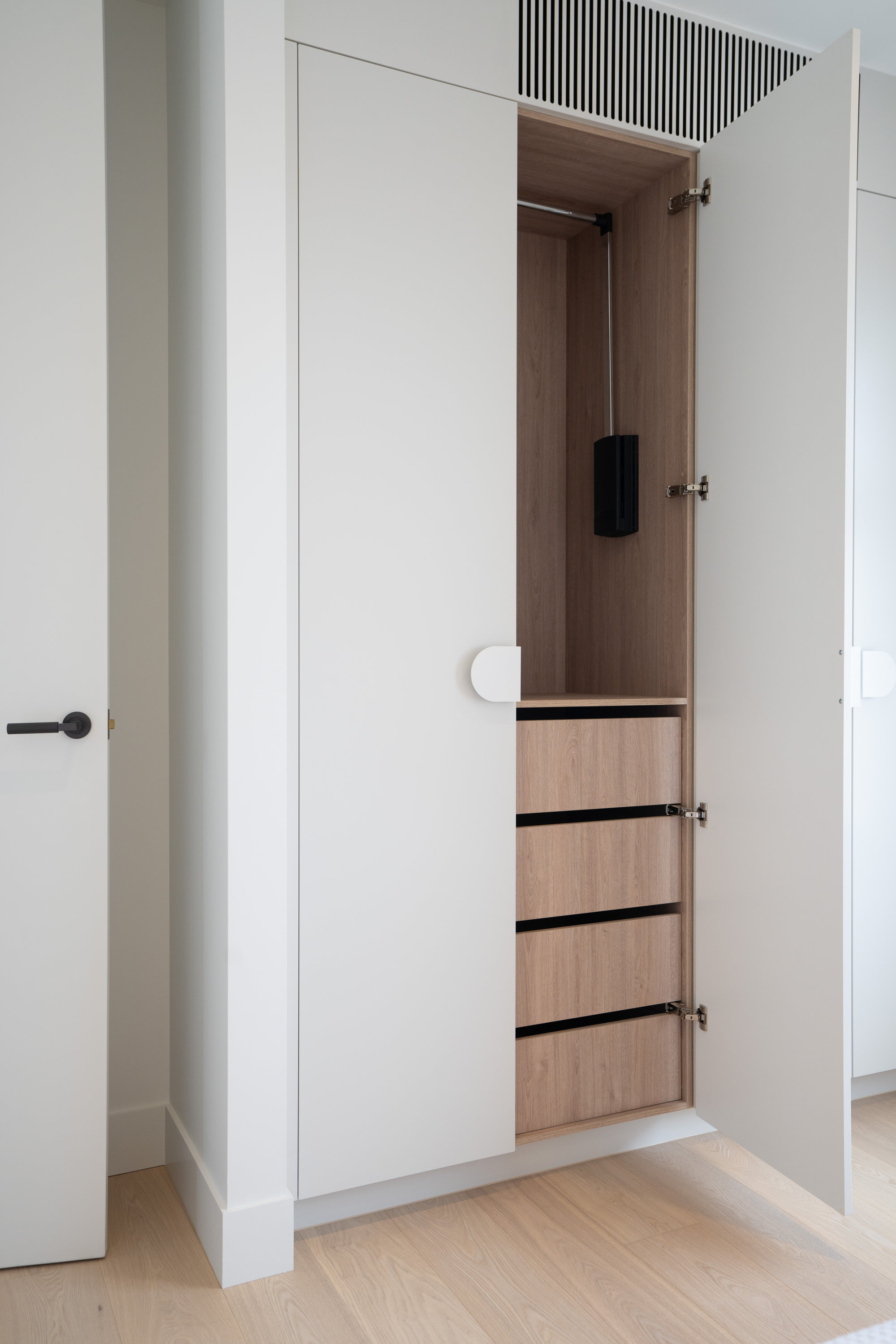 Built-in wardrobe detail with oak interior, hanging rail and drawers at 9 Netherby