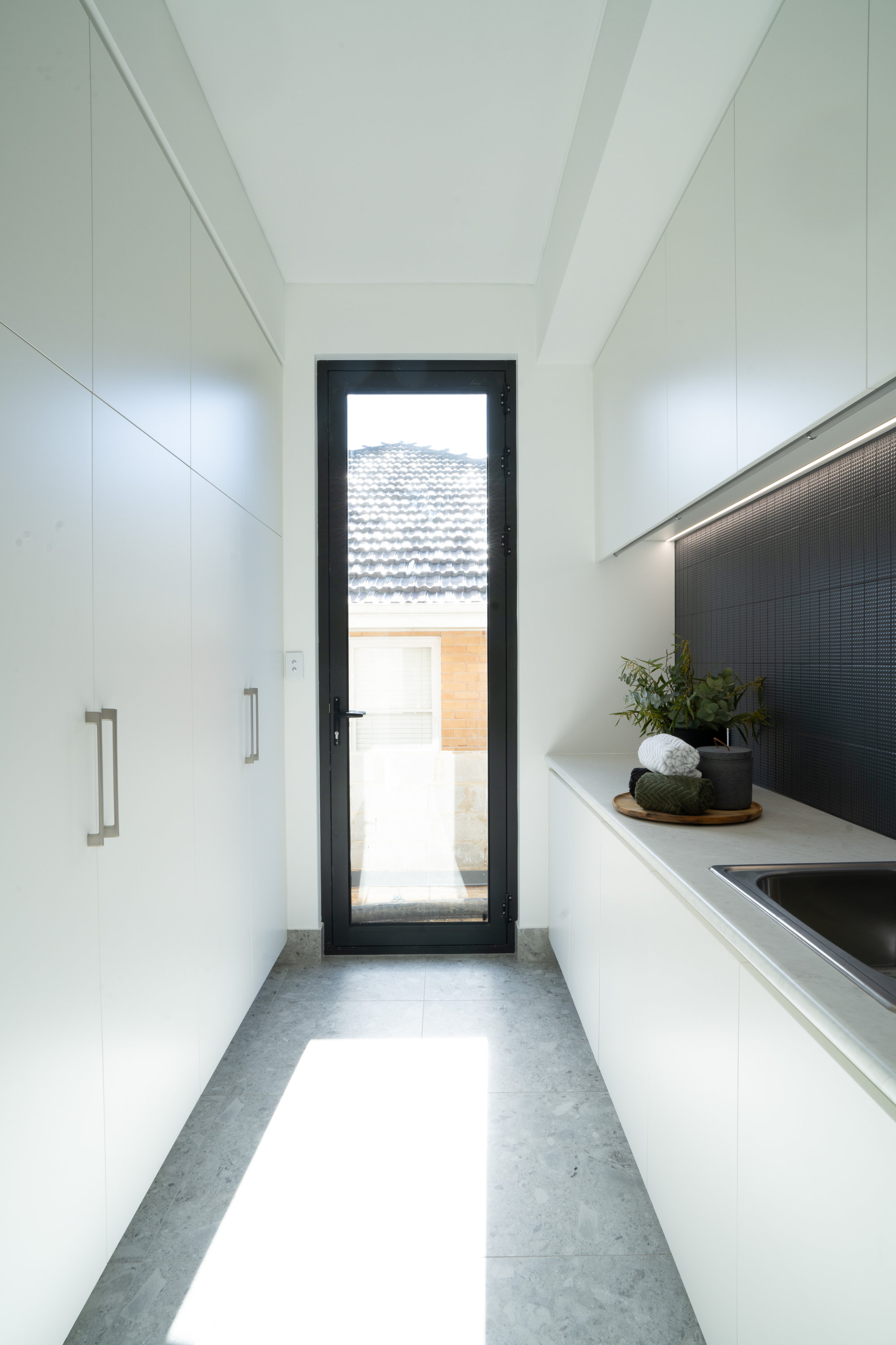 Butler's pantry with full-height joinery and a glazed door to the side courtyard at 24 Wattle Park