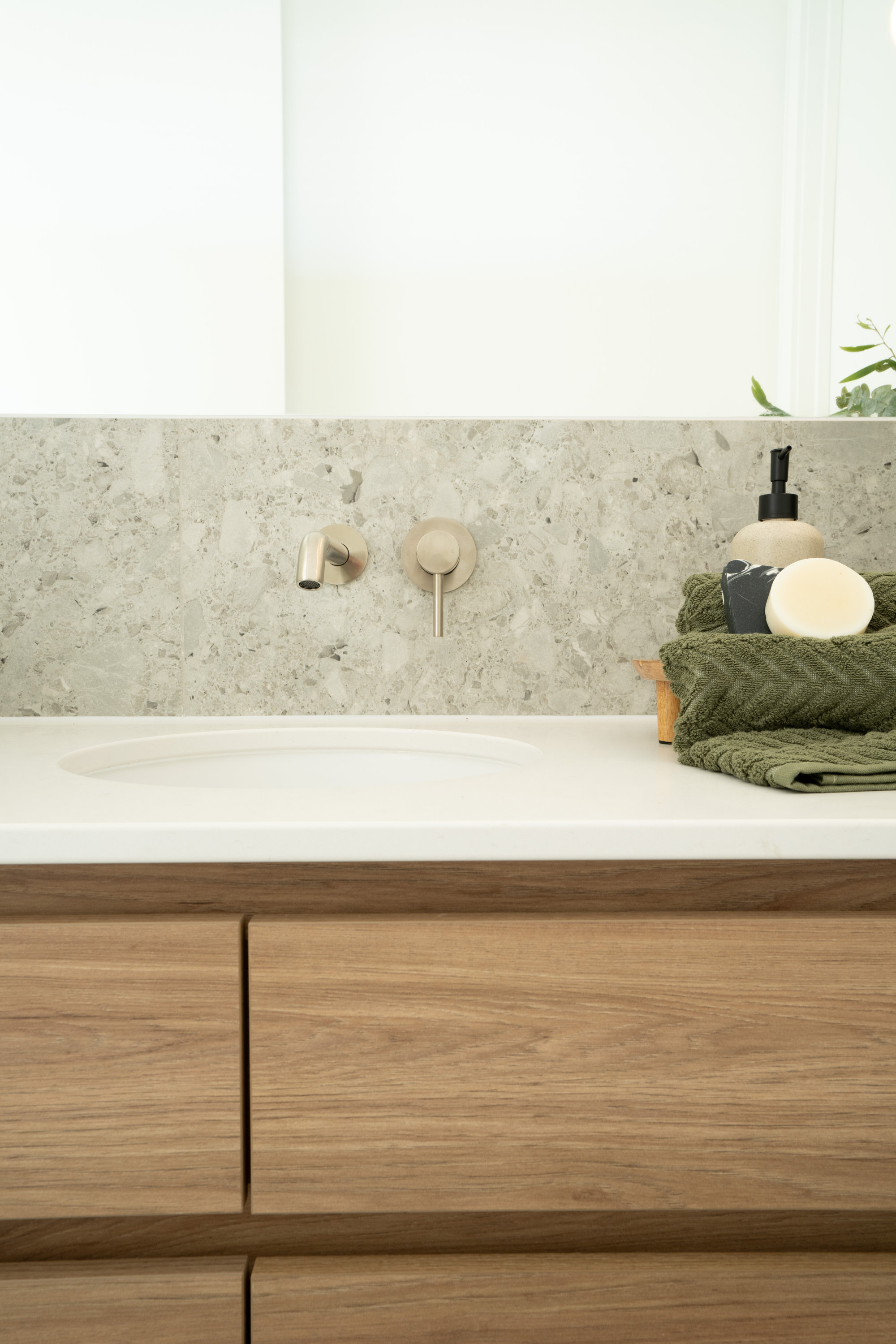 Vanity detail with terrazzo splashback and brushed nickel tapware at 24 Wattle Park