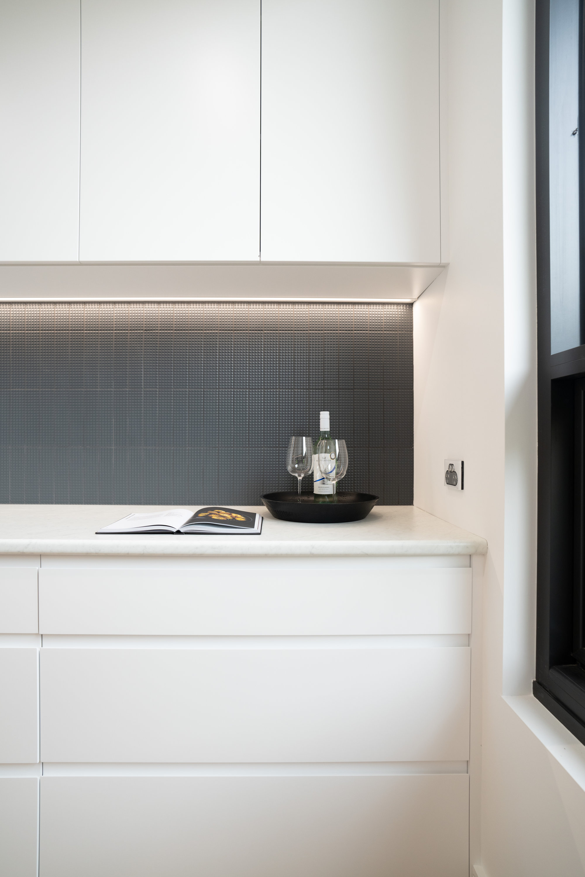 Bar and butler's area with dark mosaic splashback and stone benchtop at 24 Wattle Park
