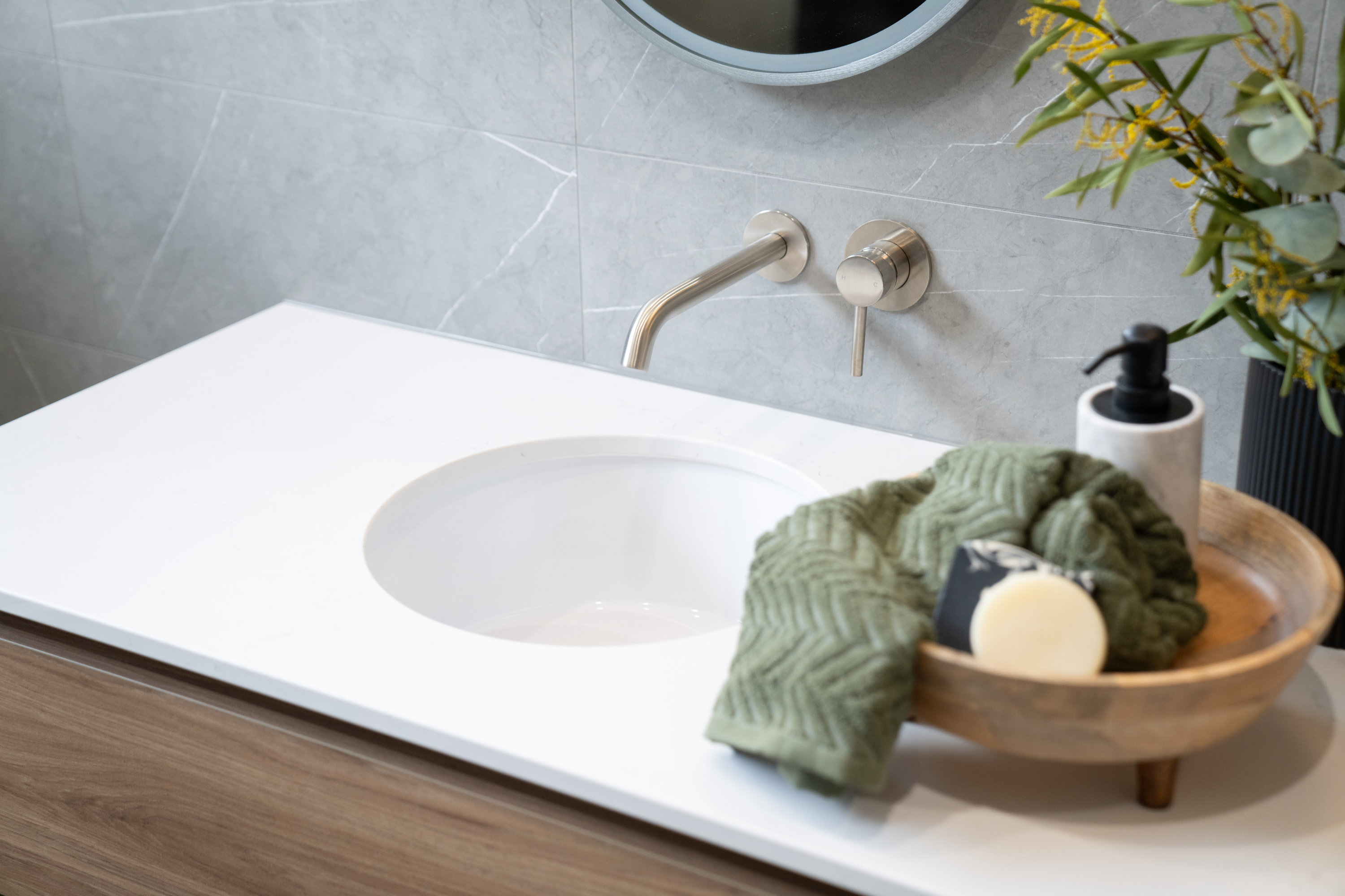 Vanity with undermount basin, brushed nickel tapware and stone-look tiling at 24 Wattle Park