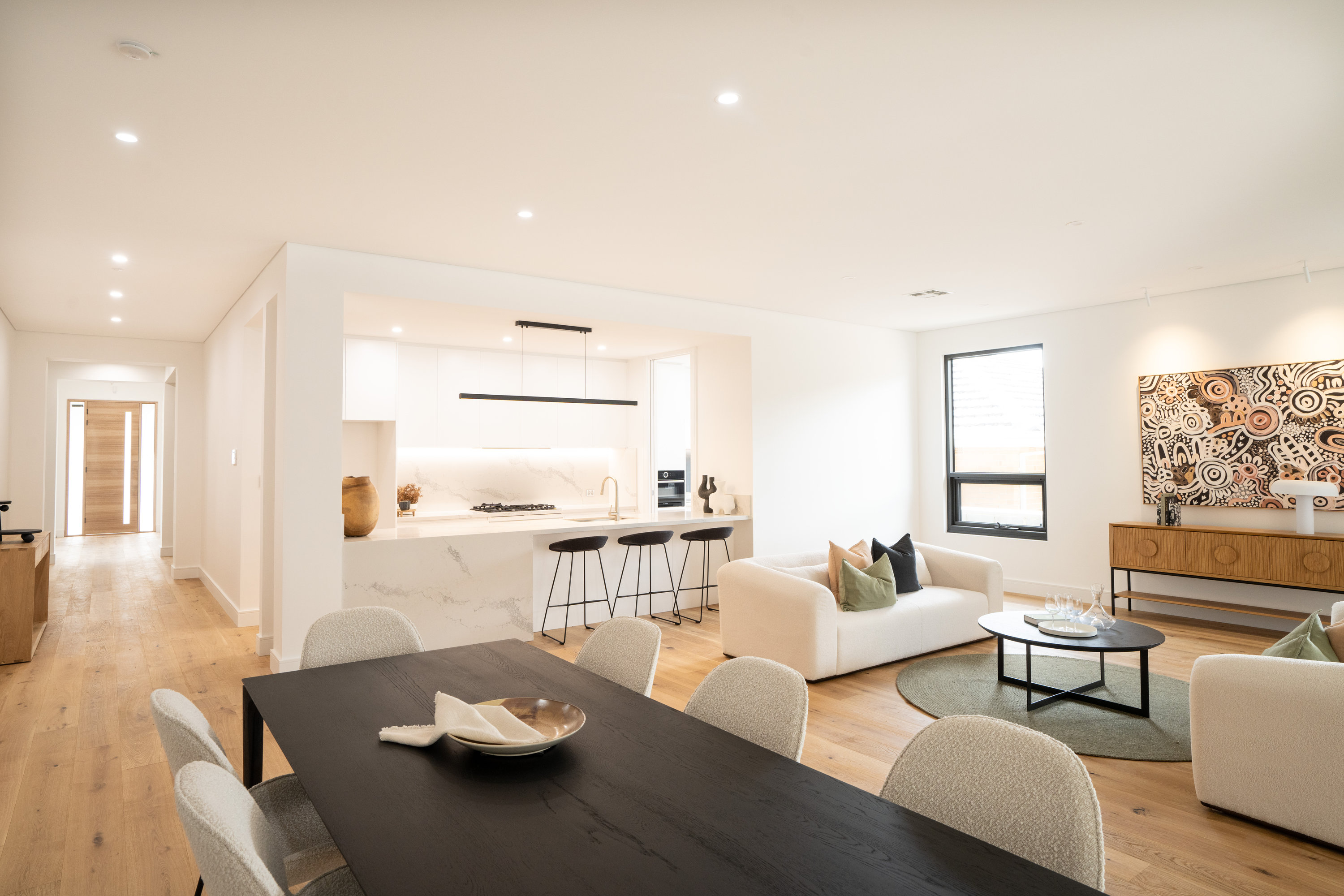 Open-plan kitchen with stone island bench opening to the connected living zones at 24 Wattle Park