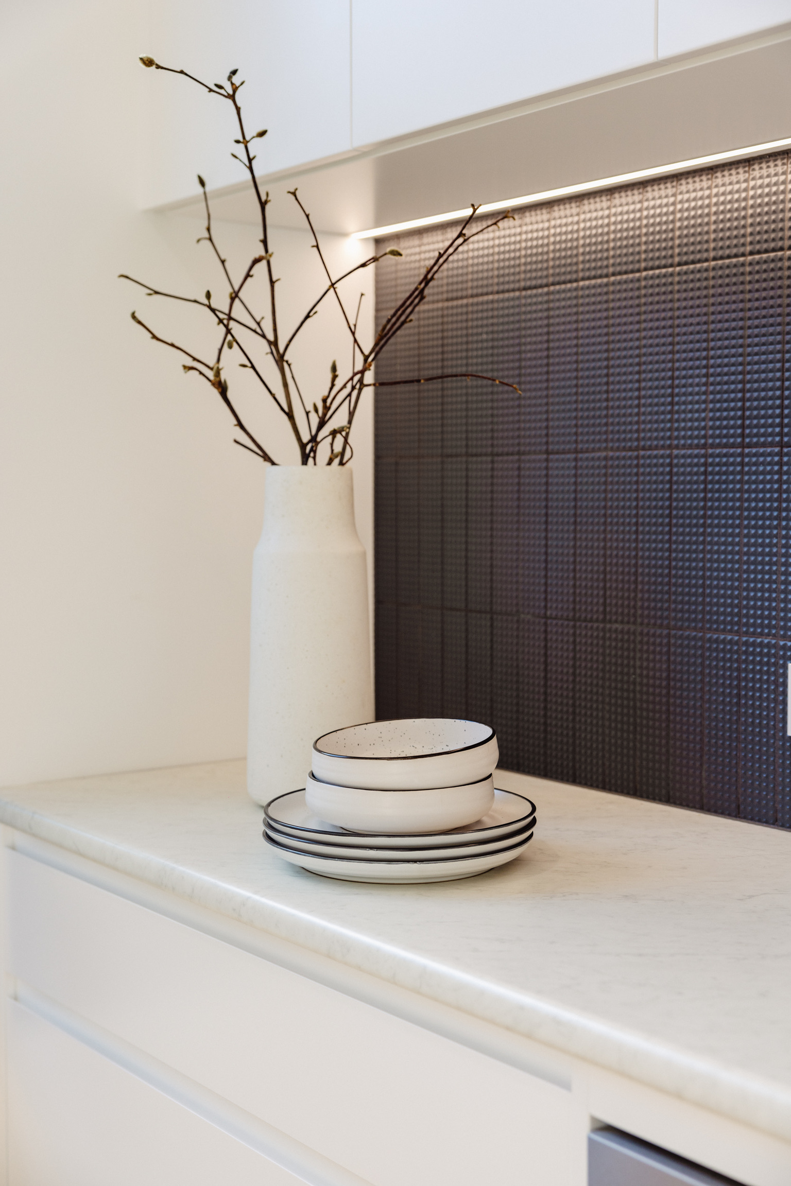 Kitchen detail with dark mosaic splashback, marble benchtop and ceramic styling at 24 Wattle Park