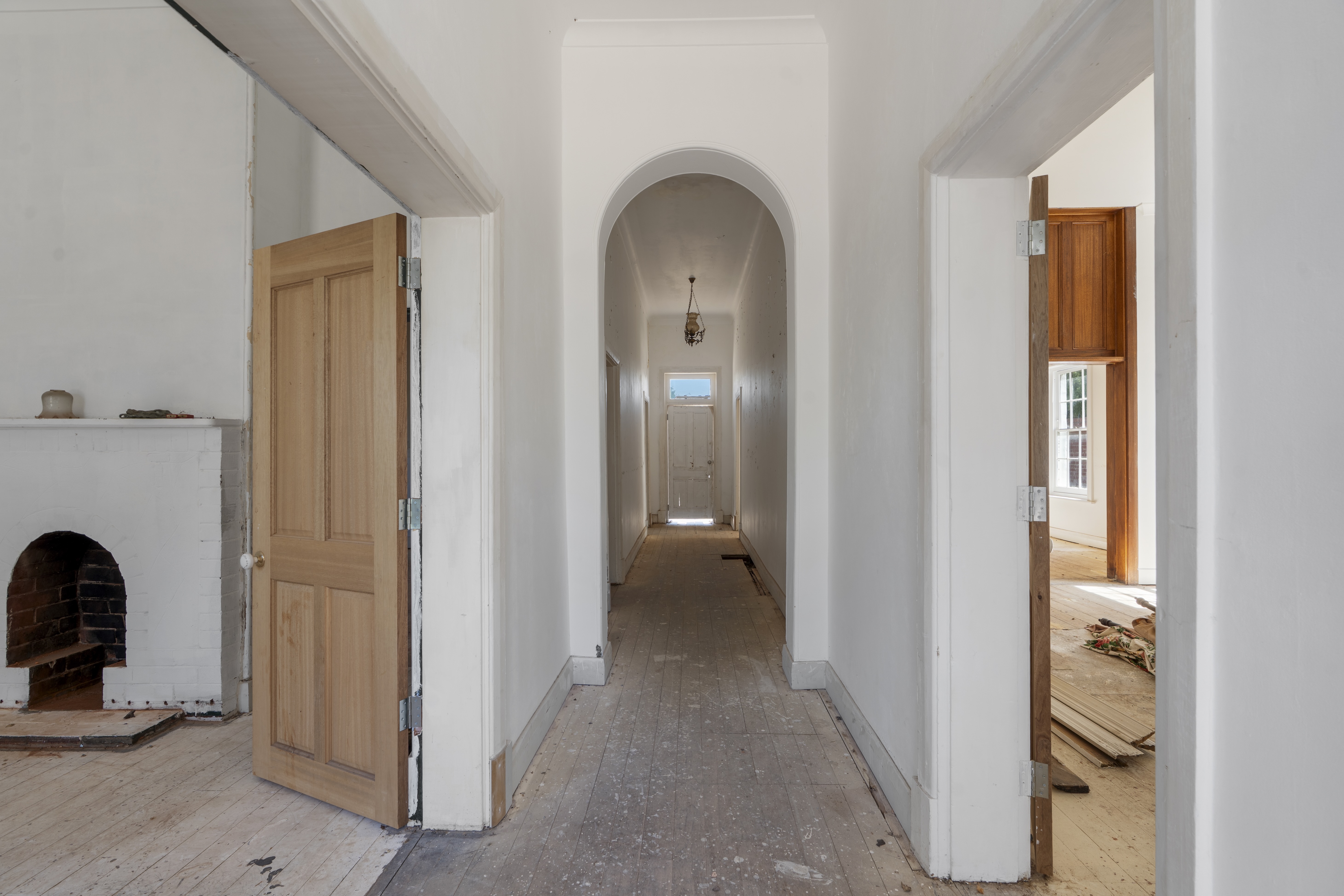 Original arched hallway and fireplace during restoration at 54 North Adelaide