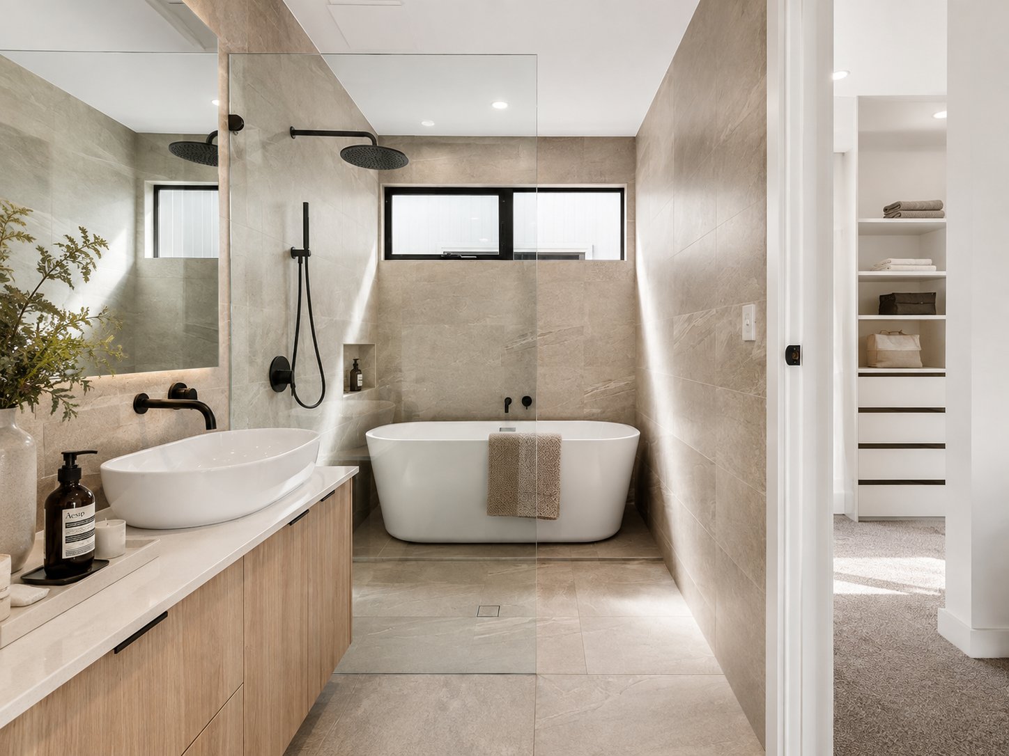 Ensuite with freestanding bath, vessel basin on a timber vanity and black tapware at 1 Magill