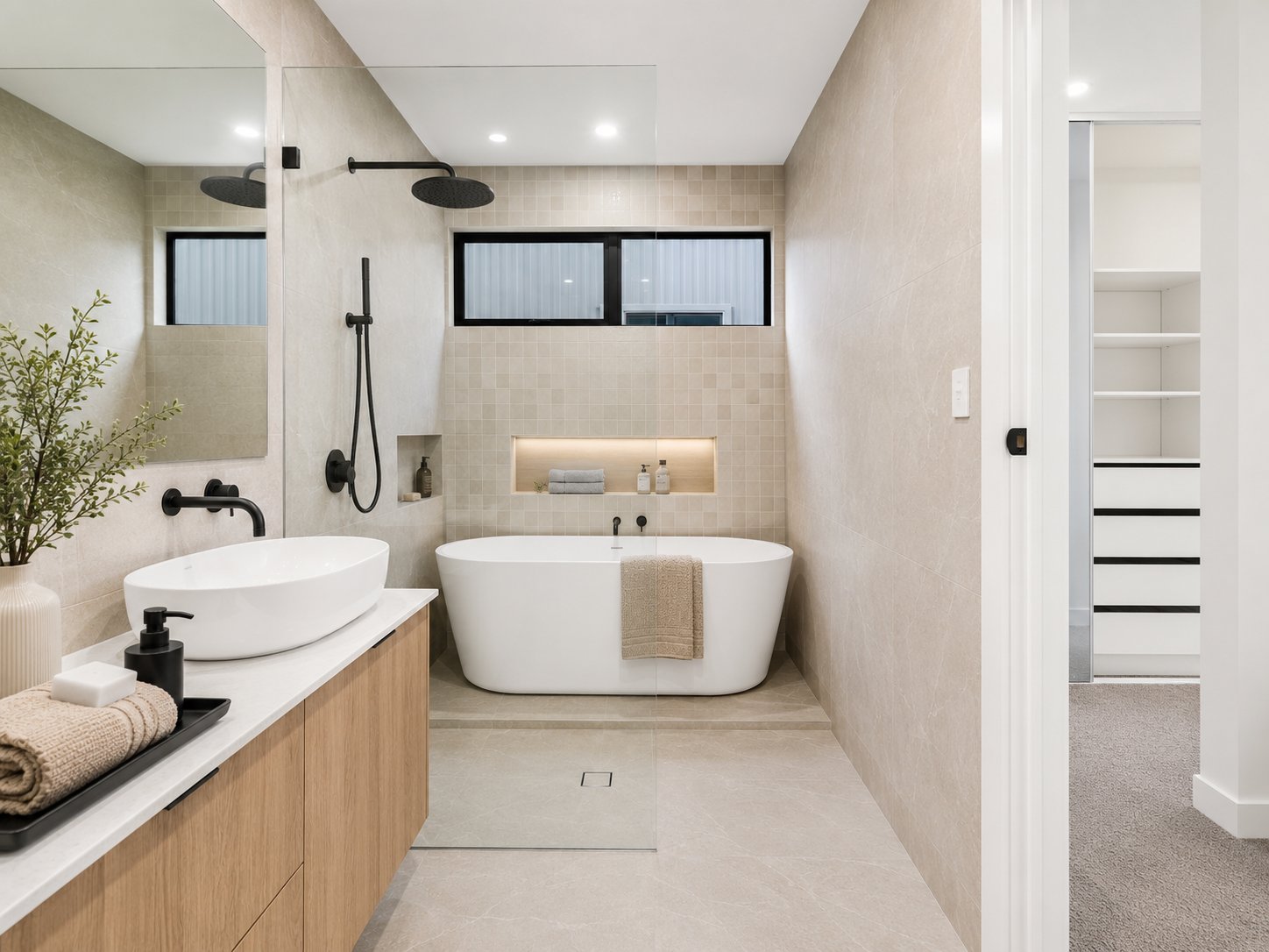 Ensuite with a freestanding bath, vessel basin and tiled feature niche at 1 Magill