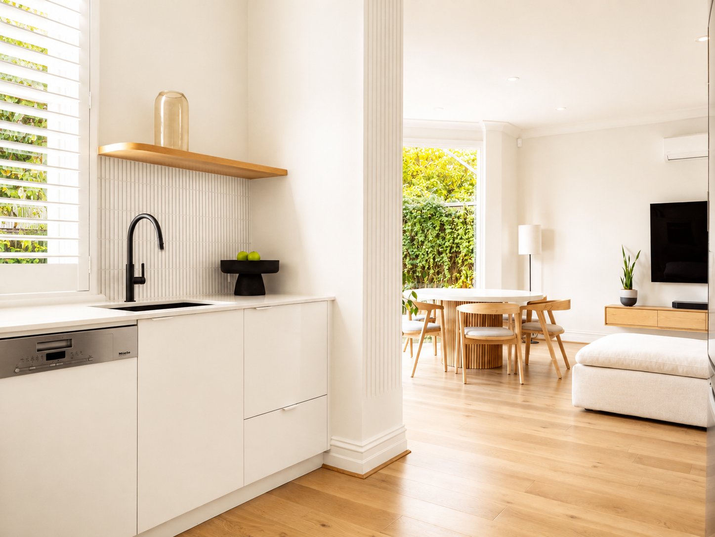 Kitchen looking through to the living and dining zone with oak flooring at 21 Norwood
