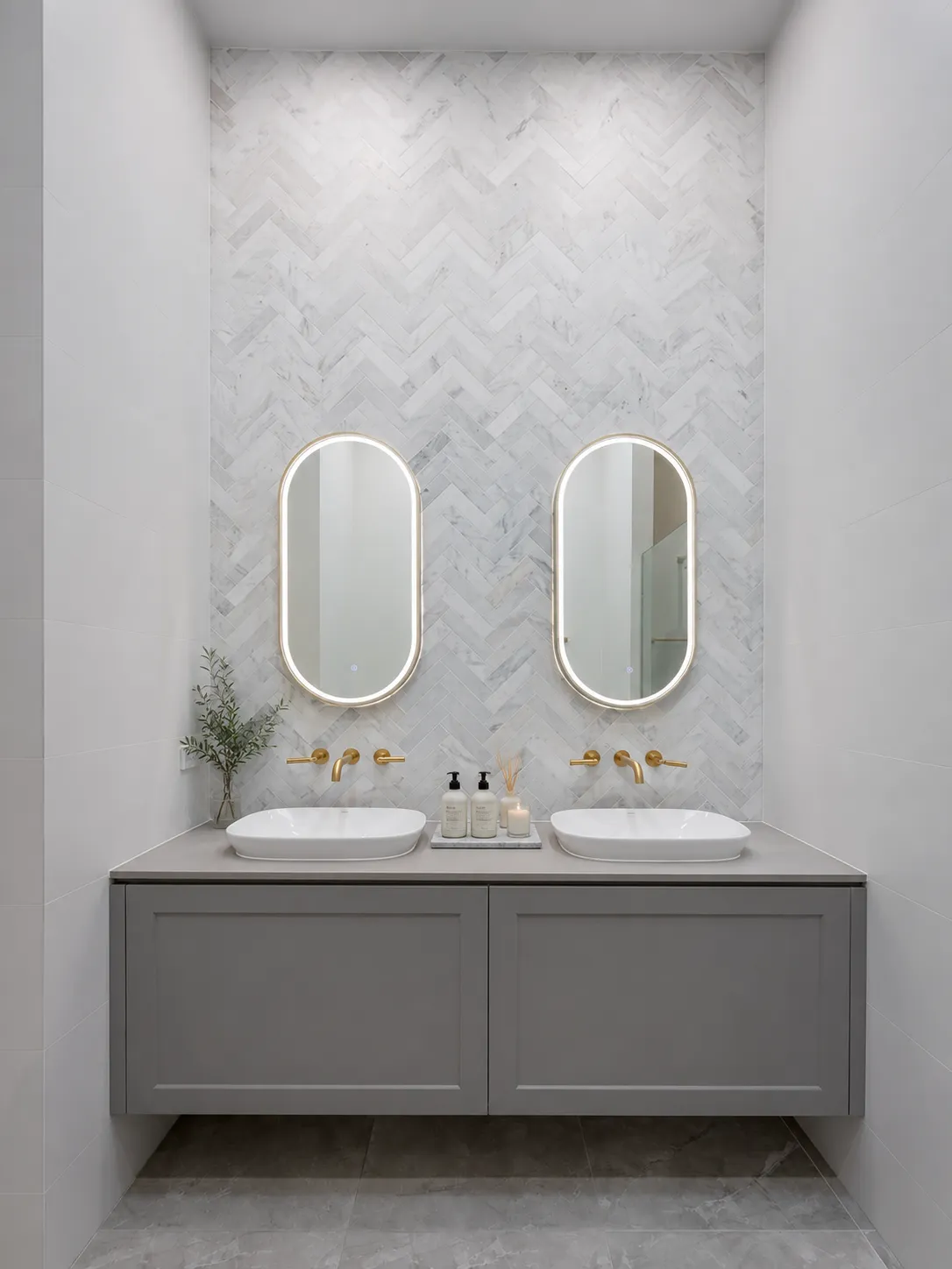 Renovated ensuite with a herringbone marble feature wall, twin backlit mirrors and a floating double vanity at 84 Toorak Gardens