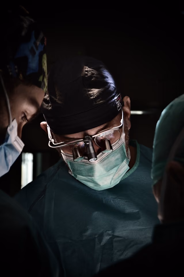Surgeons wearing magnifying loupes during an operation