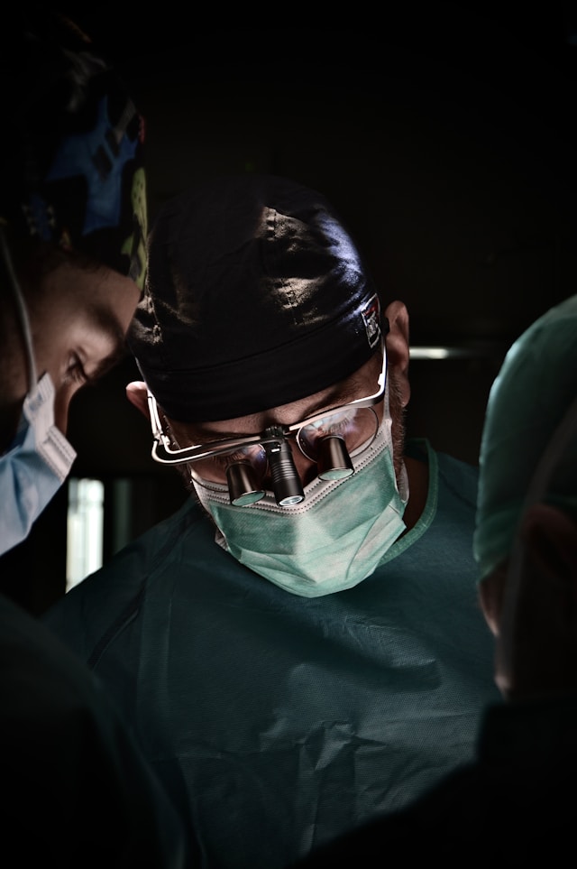 Surgeons wearing magnifying loupes during an operation