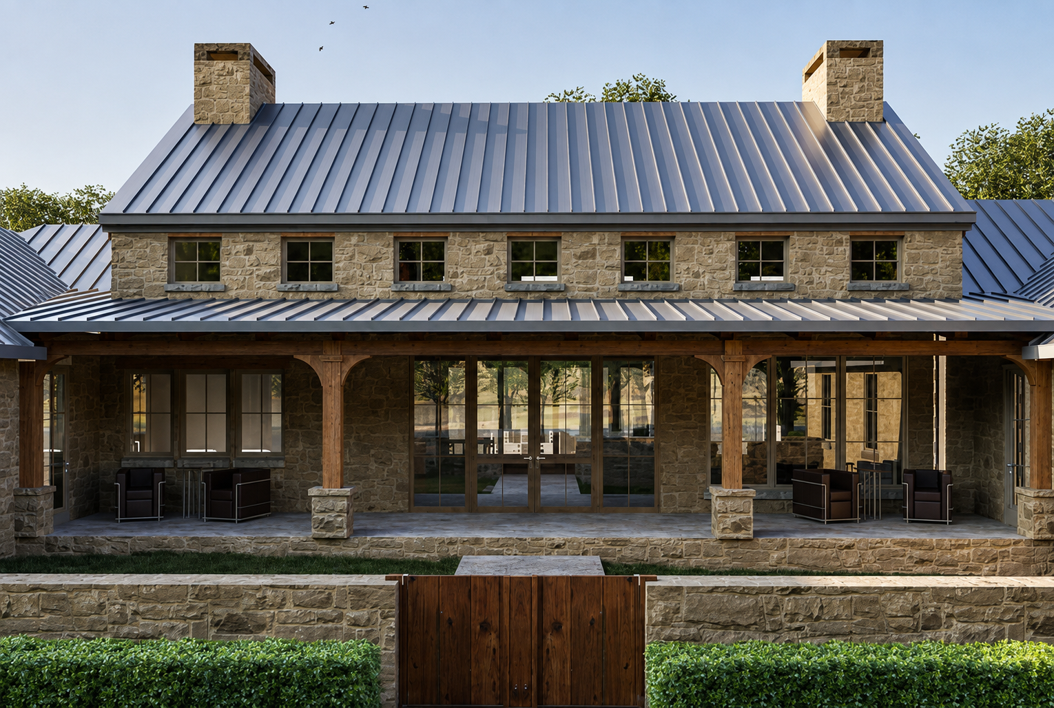 Stone house with metal roof, wooden pillars, glass doors, outdoor chairs, and green shrubs.