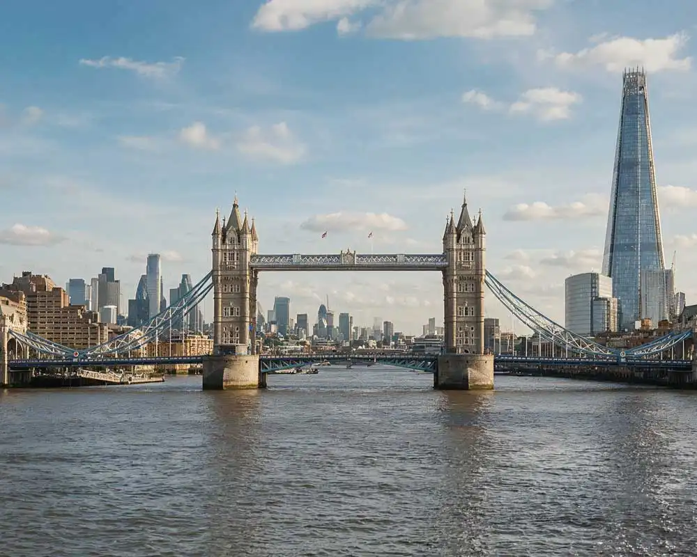 Tower Bridge over the River Thames with the Shard and the London skyline under a blue sky
