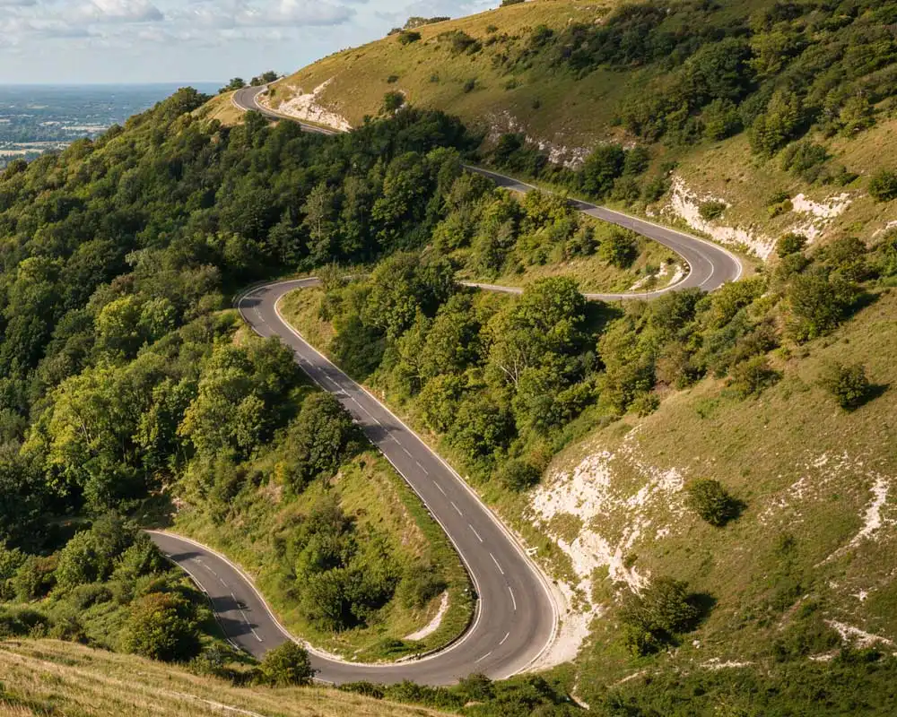 Zig-zag road winding up the wooded chalk slopes of Box Hill, with views over the Surrey countryside