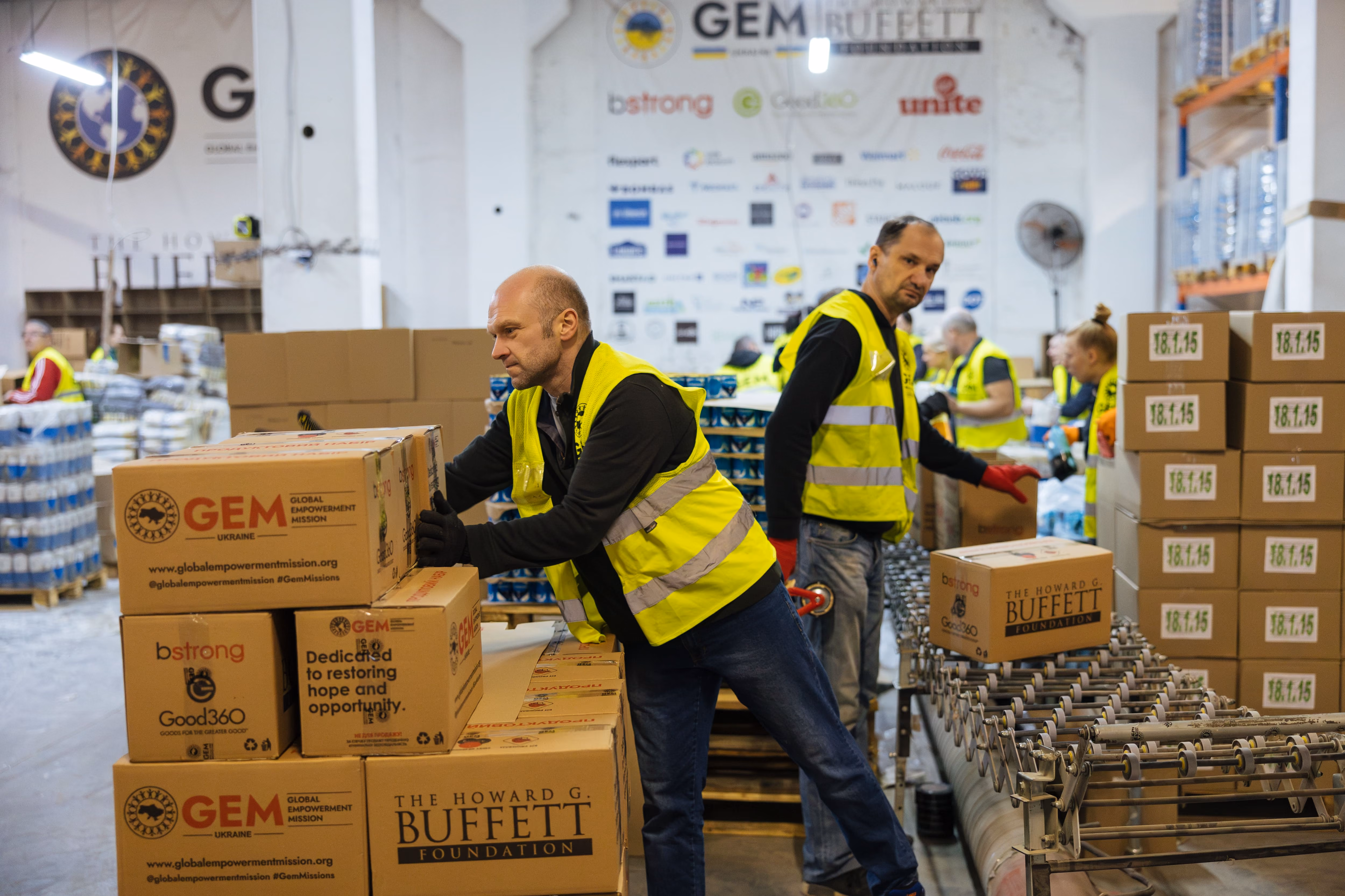 Worker packing humanitarian food boxes at a RIDNE partner warehouse