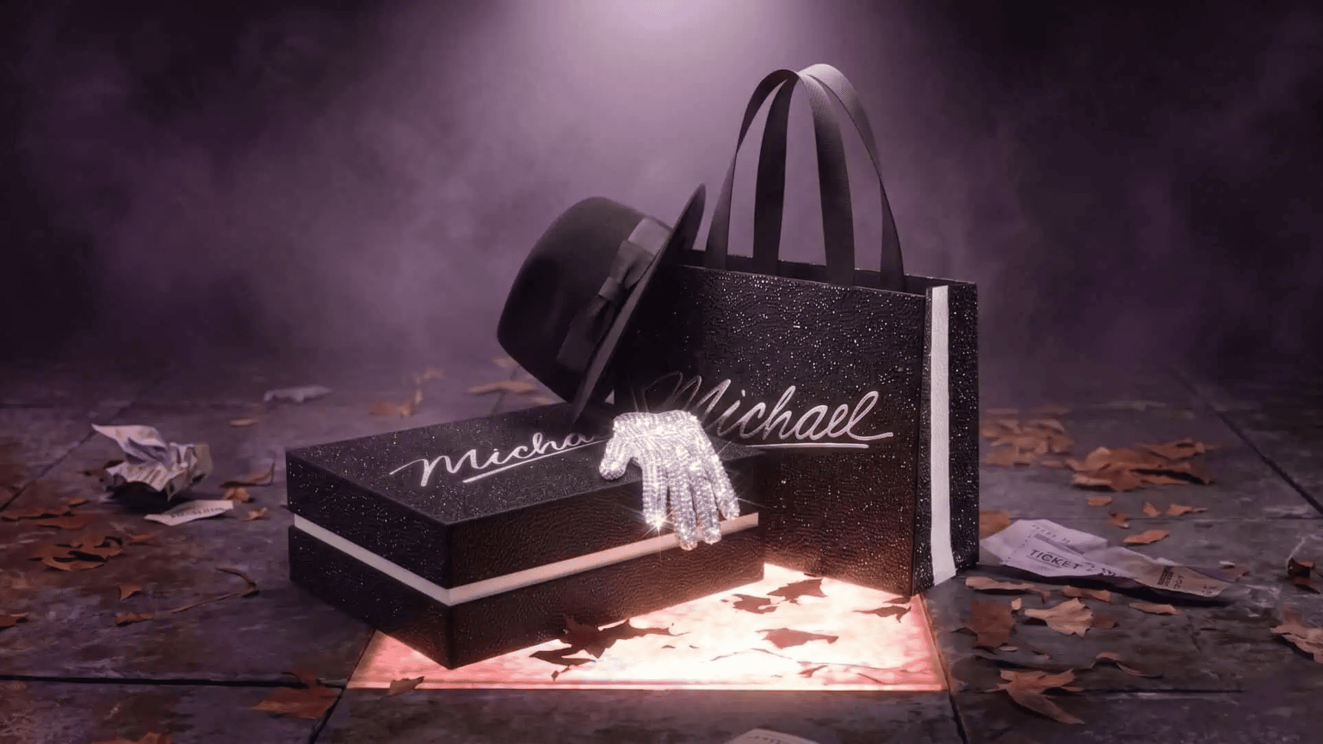 Blonde woman with glamorous makeup holding a gold Victoria's Secret shopping bag with feathered wings.