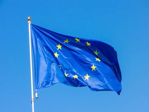 European Union flag flying in front of bright blue sky